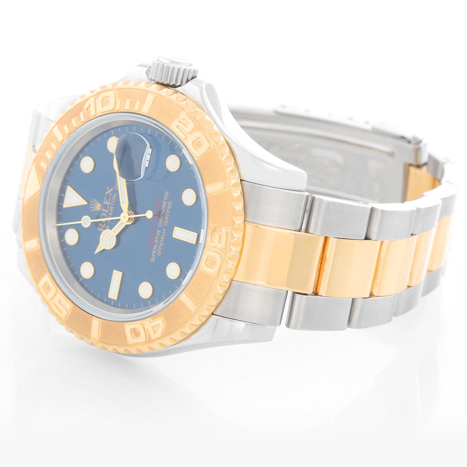 Rolex Yacht-Master Steel & Gold Men's 2-Tone Watch 16623 - Automatic winding, 31 jewels, Quickset, sapphire crystal. Stainless steel case with 18k yellow gold bezel  (40mm diameter). Factory Blue Dial. Stainless steel and 18k yellow gold Oyster
