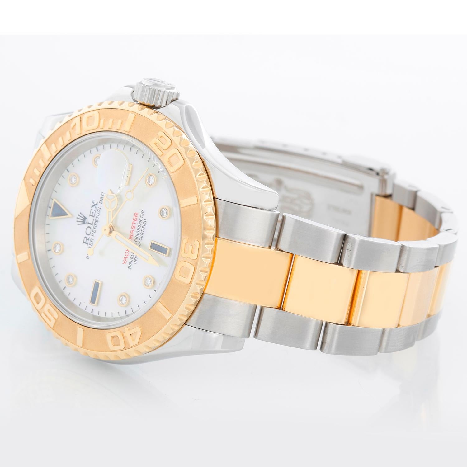 Rolex Yacht-Master Steel & Gold Men's 2-Tone Watch 16623 - Automatic winding, 31 jewels, Quickset, sapphire crystal. Stainless steel case with 18k yellow gold bezel  (40mm diameter). Mother of Pearl Sapphire dial . Stainless steel and 18k yellow