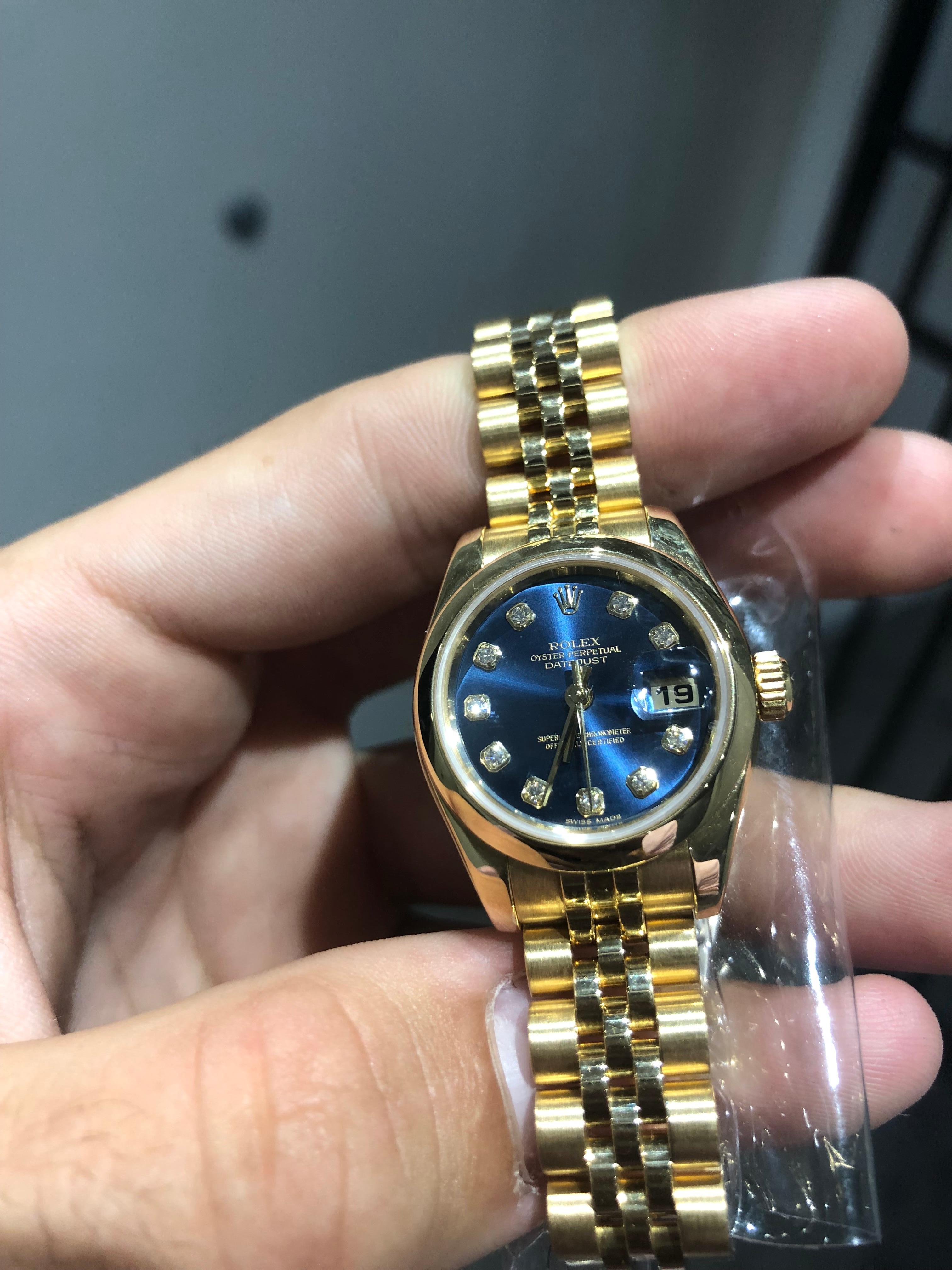 An 18k Yellow Gold Oyster Perpetual Datejust Ladies Wristwatch, blue dial with 10 applied round brilliant cut diamond hour markers, date at 3 0'clock, a fixed 18k yellow gold smooth bezel, an 18k yellow gold jubilee bracelet with a concealed 18k