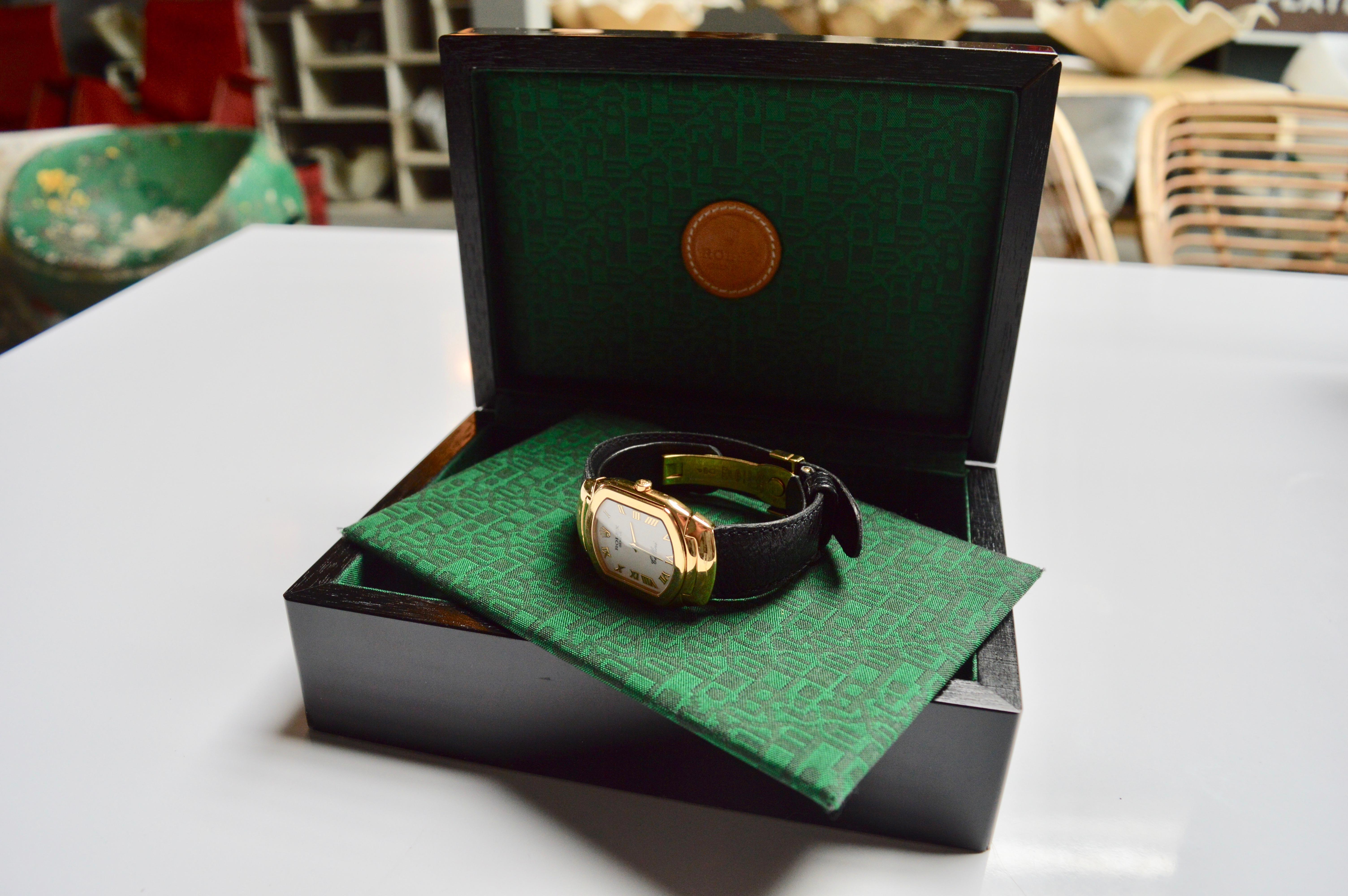 Elegant 18k yellow gold Rolex Cellini, circa 1991. Porcelain white dial with Roman numerals. Leather strap with deployment buckle. Swiss made. Quartz movement. Strap and Crown signed 18K yellow gold. Model 6633. Serial number and model number