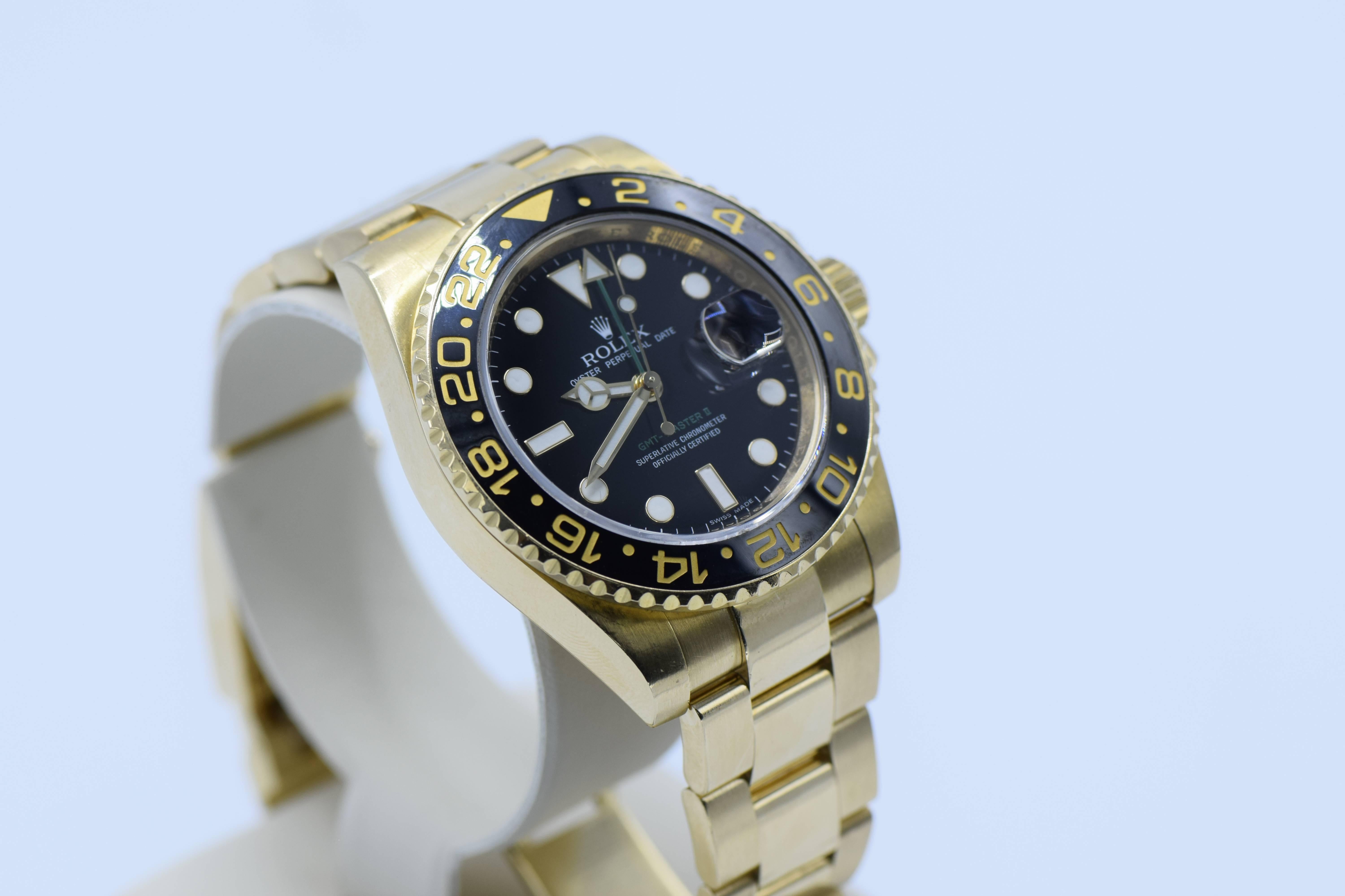 Certificate
2 Extra links 

Black Dial with Luminescent Hour Markers, Sweep Second Hand, GMT 2nd Time Zone Hand, Date Indicator
GMT 24-Hour Rotating Black Ceramic Bezel, Quickset Movement, and Crystal
Matching New Style 18K Yellow Gold Rolex