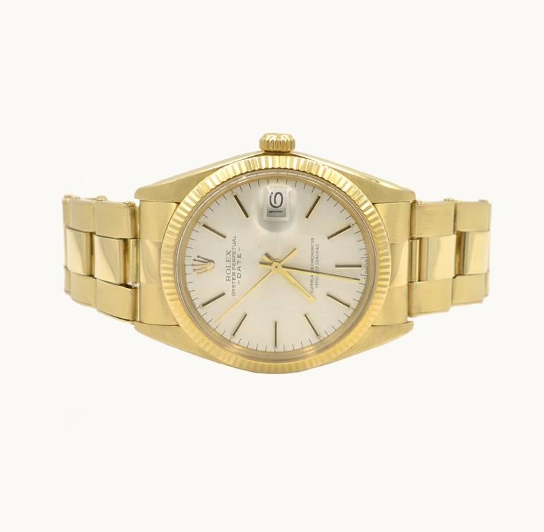 This is a beautiful Rolex Date wristwatch, reference 1503 from 1981. This 14 karat yellow gold Rolex features an original 14 karat gold oyster bracelet, a gold fluted bezel, plastic Rolex crystal, silver colored original stick dial, locking yellow