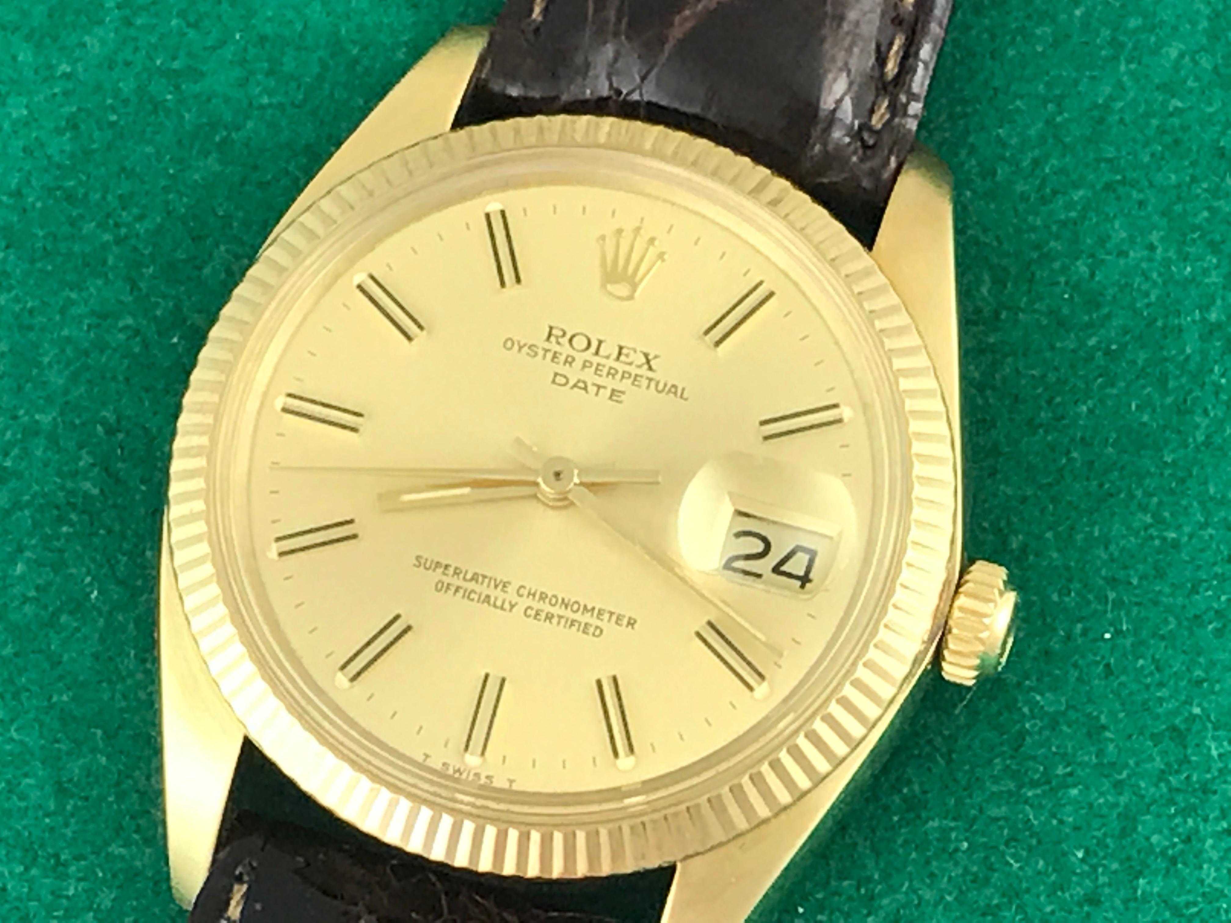 The Rolex Date Model 1503 pre-owned men's automatic wrist watch. Featuring a champagne dial with yellow gold hour markers and stainless steel case with 14K yellow gold fluted bezel. Measures 34mm. Comes with a dark brown alligator strap, box,