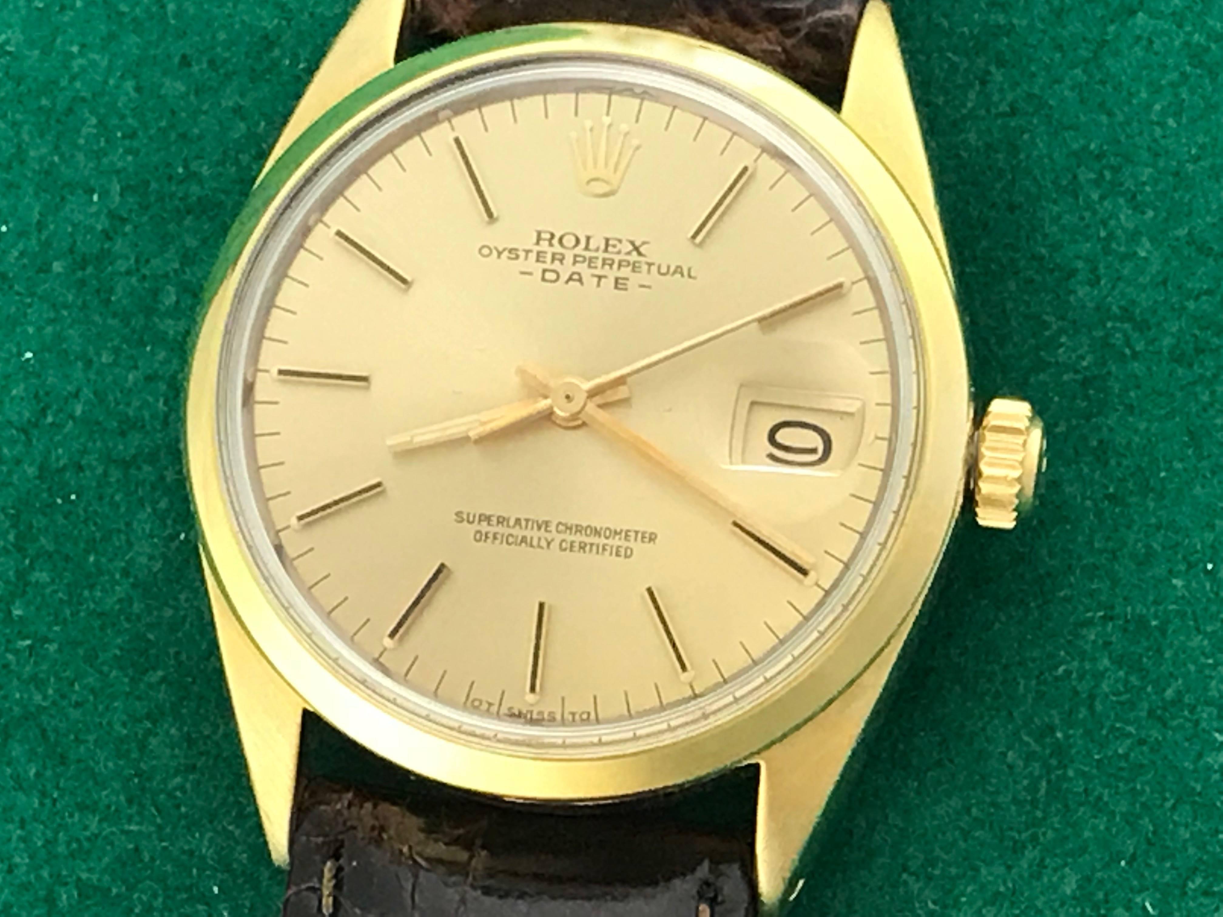 The Rolex Date Model 1550 pre-owned men's automatic wrist watch. Featuring a champagne dial with yellow gold hour markers and stainless steel case with 14K yellow gold smooth bezel. Measures 34mm. Comes with a dark brown alligator strap, box,
