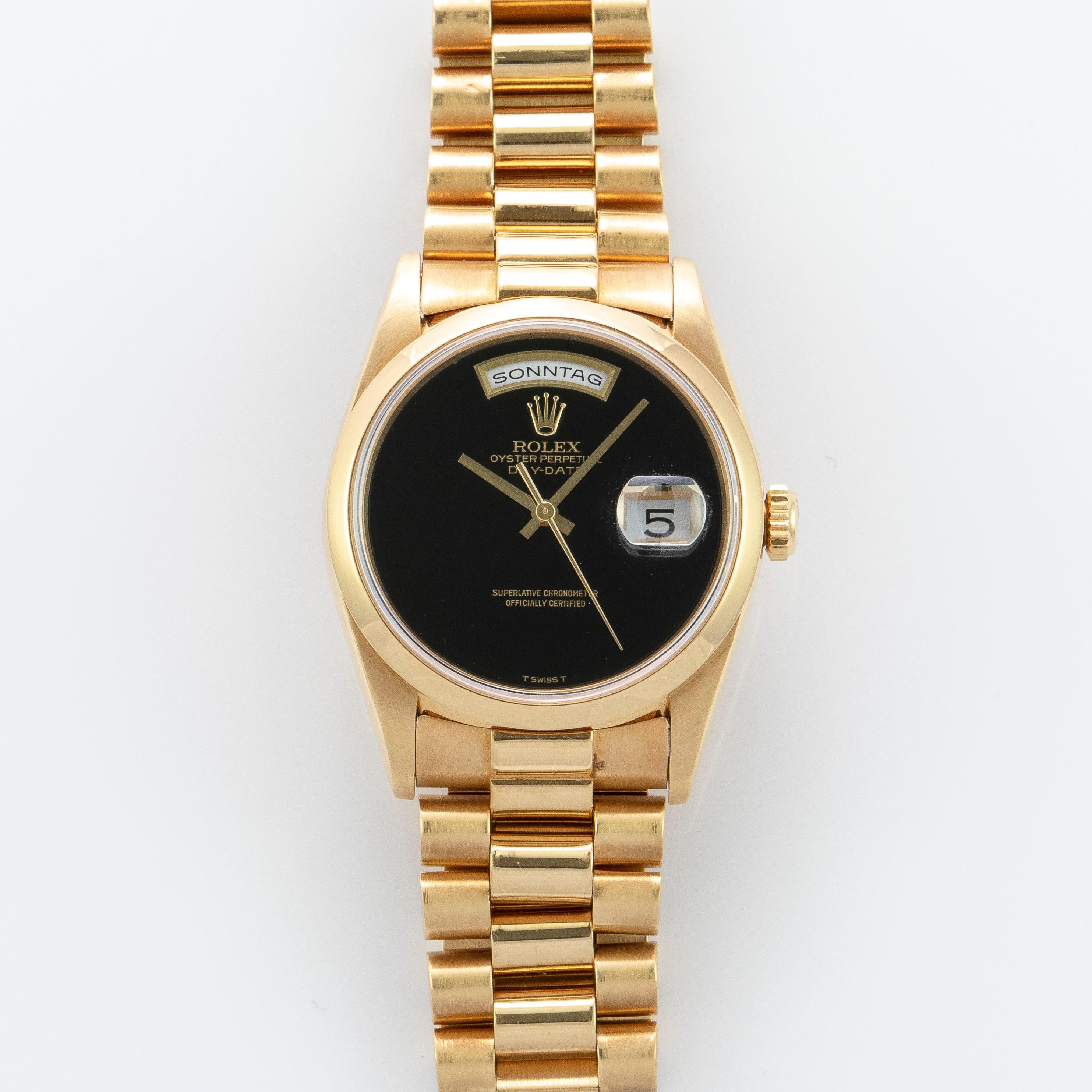 Rolex 18K Yellow Gold Day-Date Presidential Watch
Rare Factory Rolex Black Onyx T Swiss T Dial Without Hour Markers
Onyx Eye Is One Of The Rarest Rolex Stone Dials Produced
Very Unusual and Rare Dial
Rare Smooth Bezel Reference
From 1990's
18K