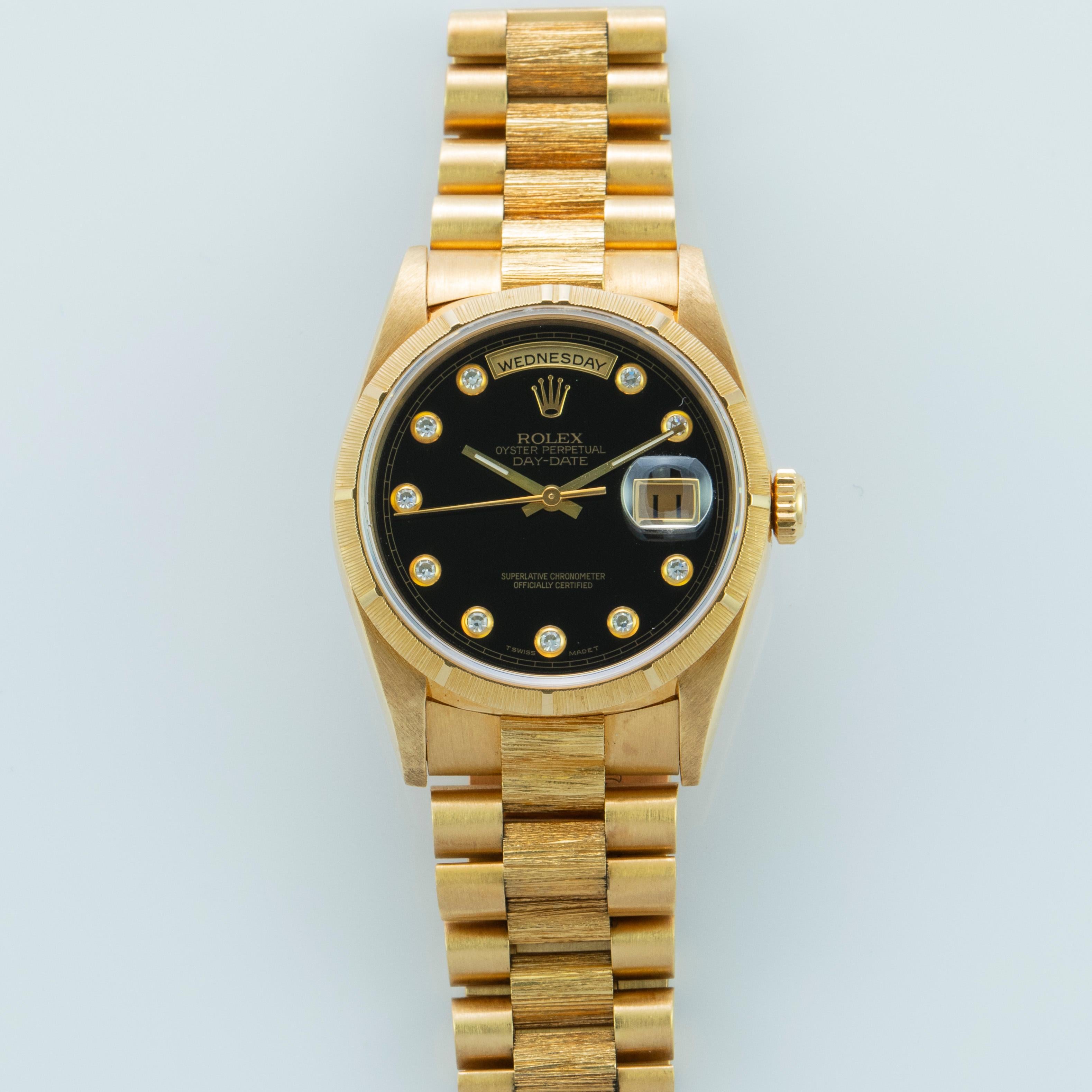Rolex 18K Yellow Gold Day-Date Presidential Watch with Factory Bark Finish
Rare Factory Rolex Black Onyx Serti Dial with Bezel Set Diamond Hour Markers 
Onyx Serti Is One Of The Rarest Rolex Stone Dials Produced
Very Unusual and Rare Dial
Rare Bark