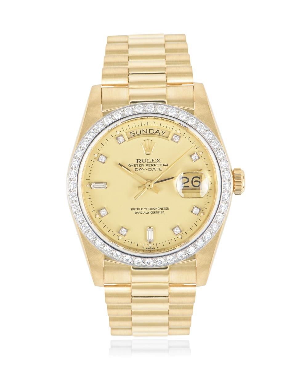 A yellow gold 36mm Day-Date by Rolex, featuring a champagne dial set with 2 baguette-cut and 8 round brilliant cut diamond hour markers with the bezel also set with approximately 44 round brilliant cut diamonds.

The president bracelet and concealed