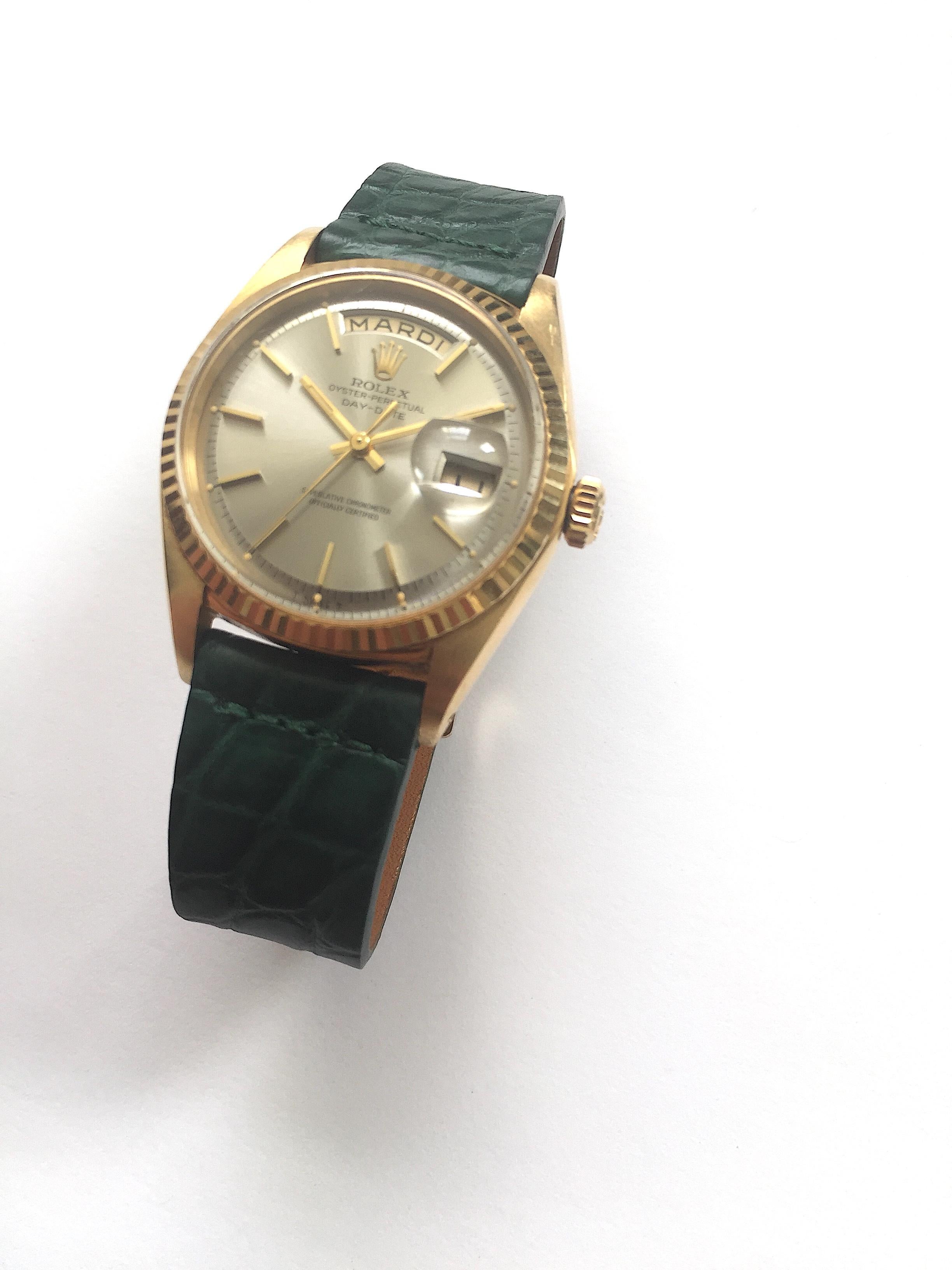 Rolex 18K Yellow Gold Day-Date Watch from the 1960s
Beautiful Factory Grey/Taupe Colored Dial with Applied Hour Markers 
Yellow Gold Gold Fluted Bezel
18K Yellow Gold Case
36mm in size 
Features Rolex Automatic Movement with Non-Quick Day and Date