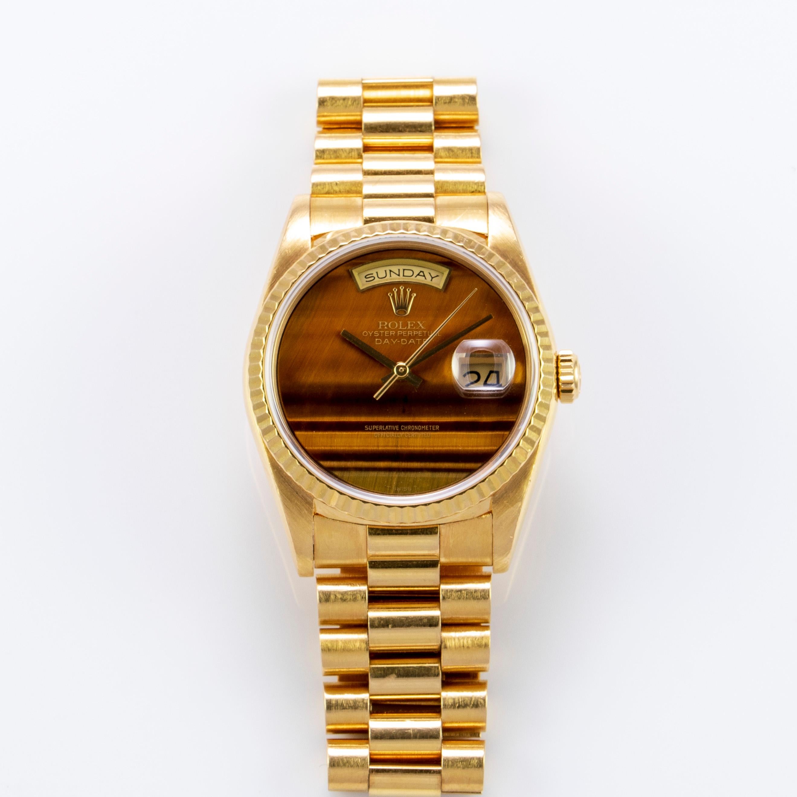 Rolex 18K Yellow Gold Day-Date Presidential Watch
Rare Factory Rolex Tiger's Eye Dial Without Hour Markers
Tiger's Eye Is One Of The Rarest Rolex Stone Dials Produced
The Dial  Has a Small Crack Seen with A Loupe and Under Magnification at Eleven