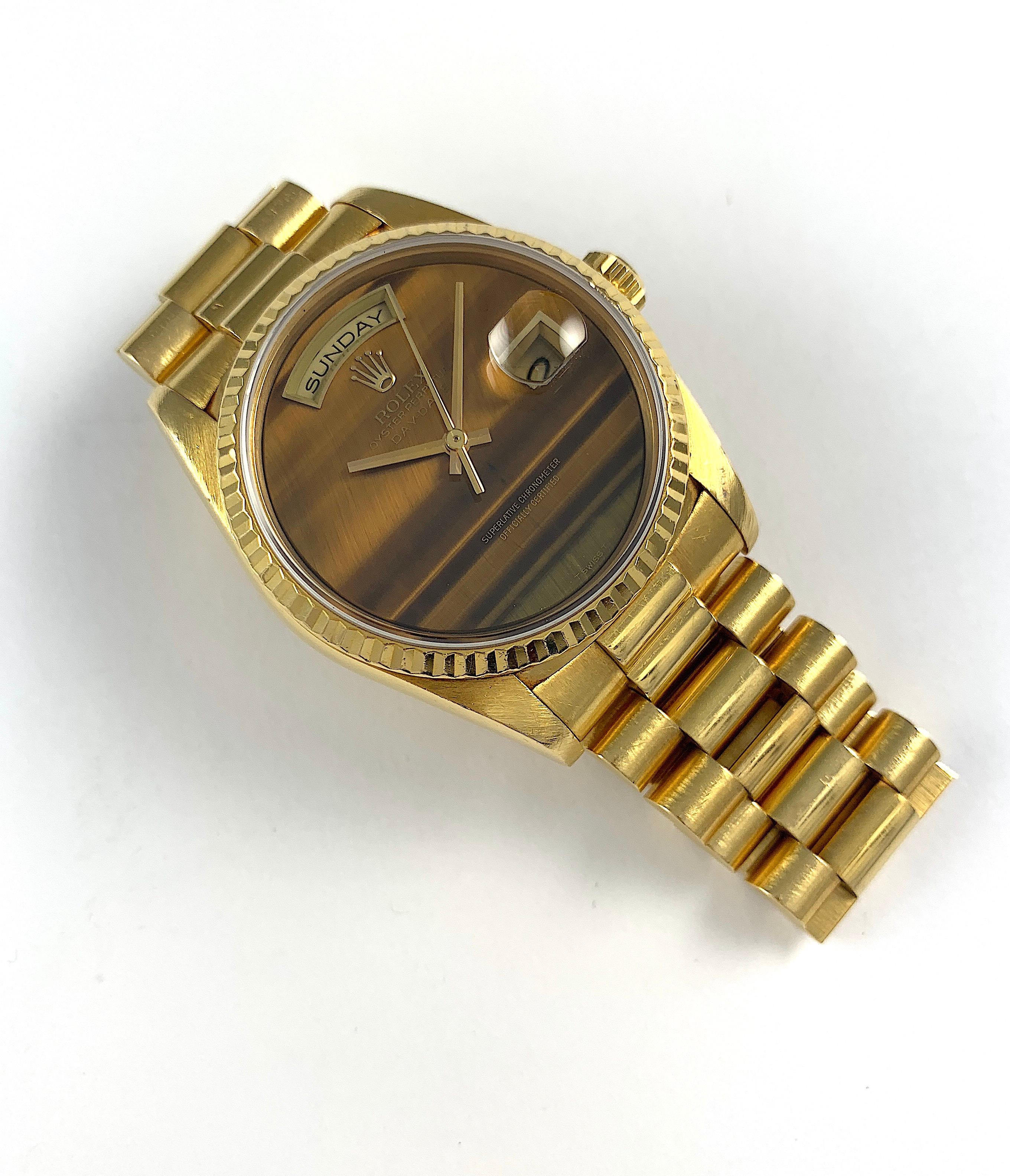 Rolex 18K Yellow Gold Day-Date Presidential Watch
Rare Factory Rolex Tiger's Eye Dial Without Hour Markers
Tiger's Eye Is One Of The Rarest Rolex Stone Dials Produced
The Dial  Has a Small Crack Seen with A Loupe and Under Magnification at Eleven