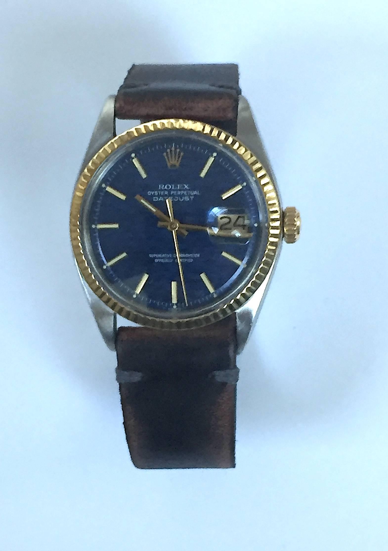 Rolex Stainless Steel and Yellow Gold Oyster Perpetual Datejust Watch
Rare Factory Blue Linen/Wave Dial with Applied Gold Hour Markers
Yellow Gold Fluted Bezel
Stainless Steel Case
36mm in size 
Features Rolex Automatic Movement with Calibre 1570