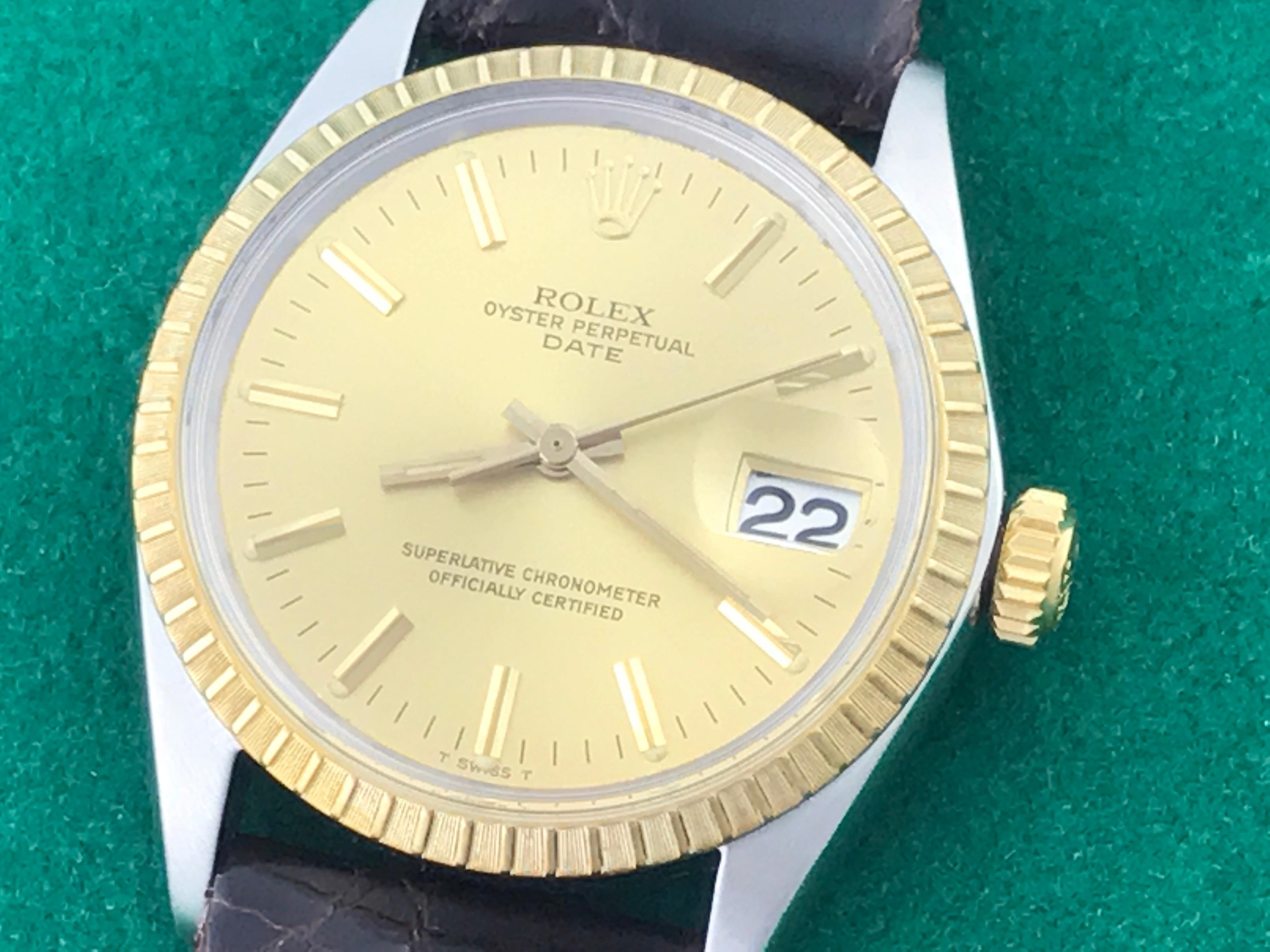 The Rolex Datejust Model 1601 pre-owned men's automatic wrist watch. Featuring a champagne dial with yellow gold hour markers and stainless steel case with 14k yellow gold fluted bezel. Measures 35mm. Comes with a dark brown alligator strap, box,