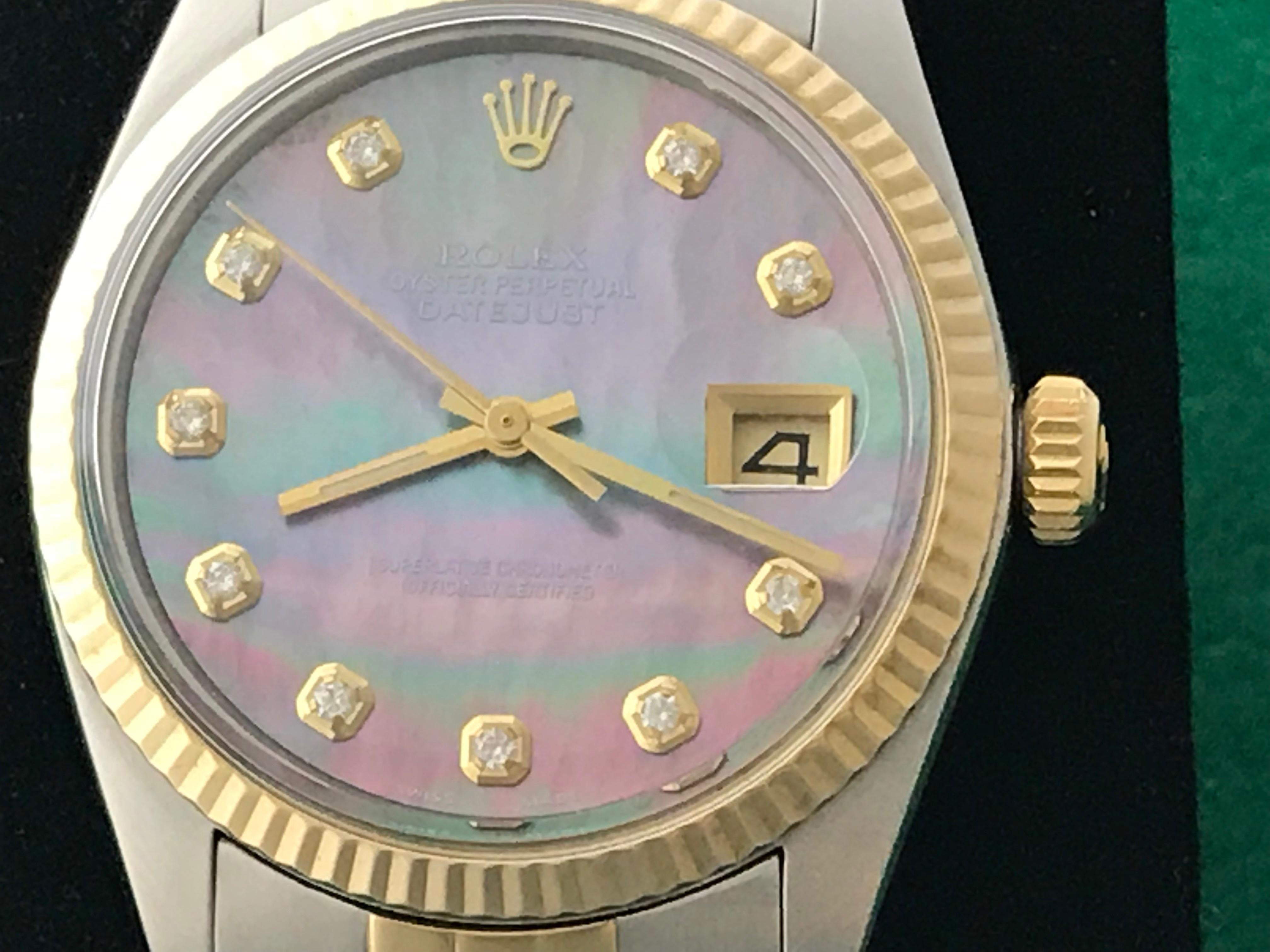 Mens Rolex Datejust Ref 16013. Certified pre-owned and ready to ship.  Oyster Perpetual, Automatic Winding Movement.  Rolex dark Mother of Pearl Dial with Rolex Diamond hour markers, surrounded by a Stainless Steel case with 18k Yellow Gold fluted