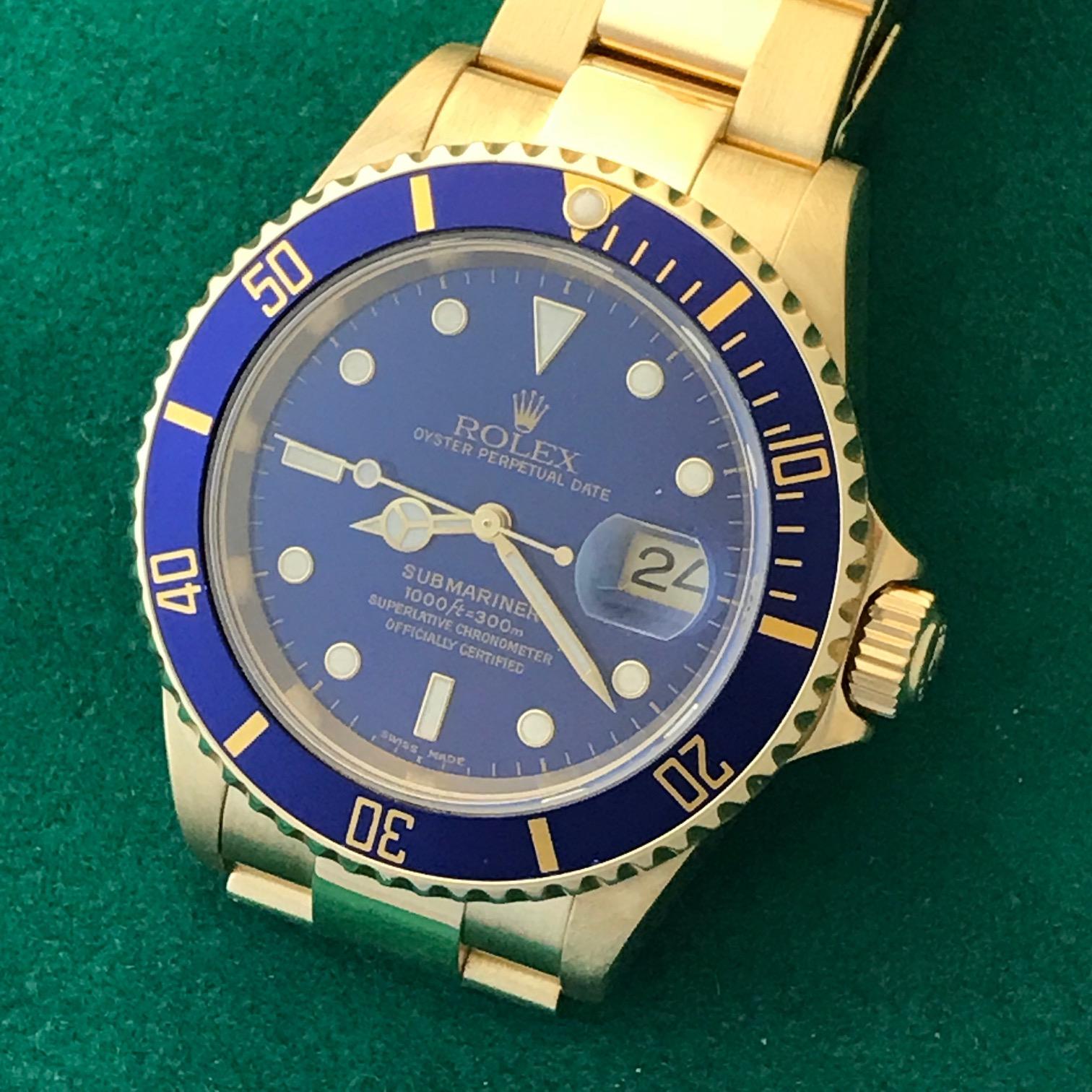 Like New Rolex Mens Submariner Model 16618 at a great price.  Automatic Winding Oyster Perpetual Date Movement.  Features an 18k Yellow Gold case with Blue Bezel insert, diameter 41mm. 18k Yellow Gold Oyster bracelet with flip-lock clasp.  Blue Dial