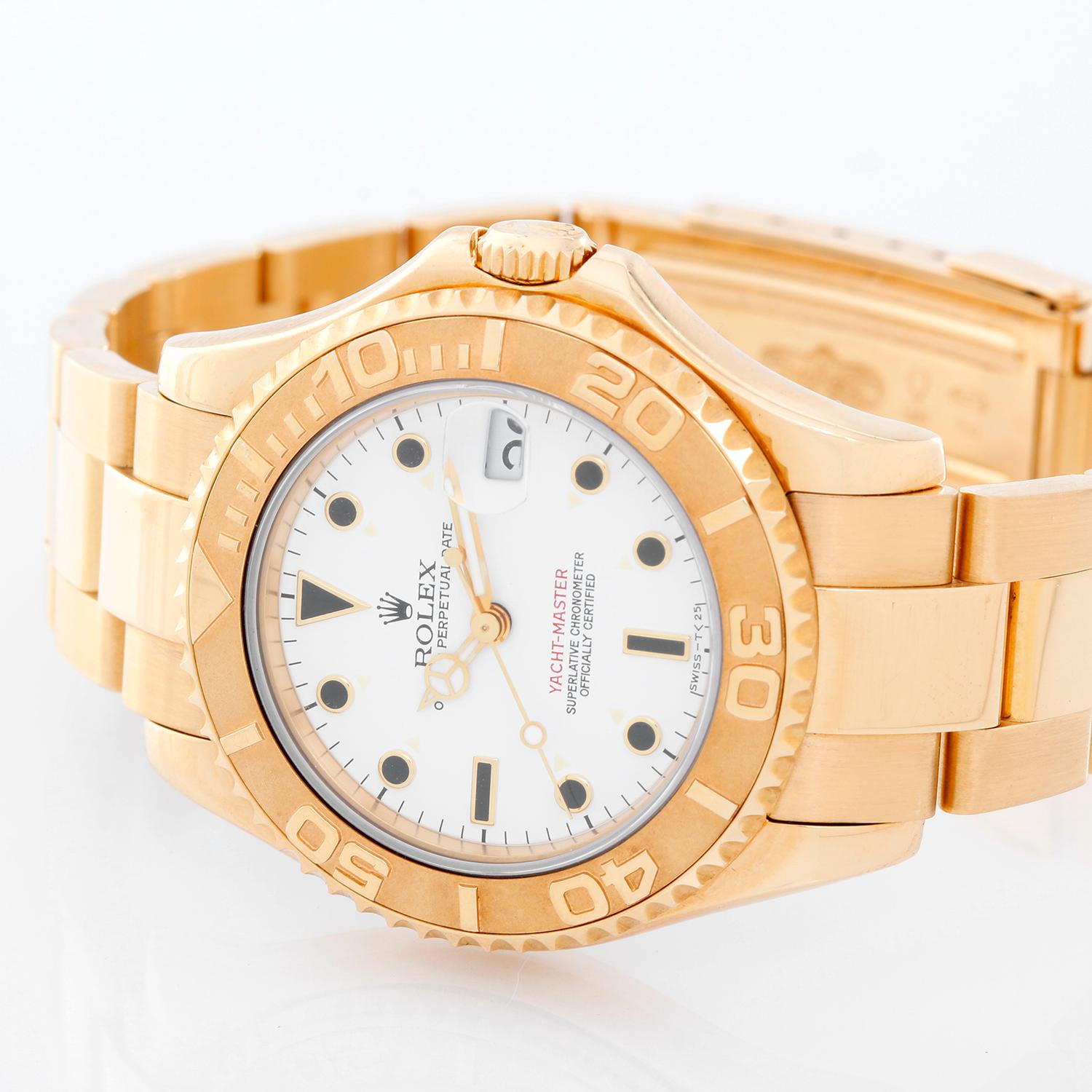 Rolex Yacht-Master Midsize Men's/Ladies 18k Gold Watch 68628 - Automatic winding, 29 jewels, sapphire crystal. 18k yellow gold case with rotating bezel (35mm diameter). White dial with black markers. 18k yellow gold Oyster bracelet with flip-lock