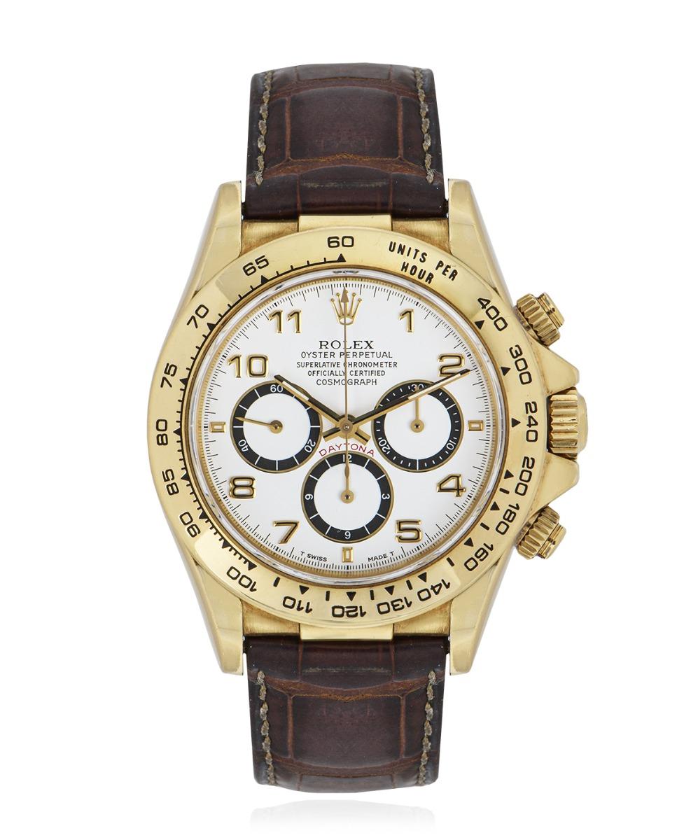 A Zenith Cosmograph Daytona in yellow gold by Rolex, featuring a white arabic dial. The dial features a 12 hour counter with an inverted 6 and a small seconds display. Features an engraved tachymetric scale on the bezel.

Equipped with an original