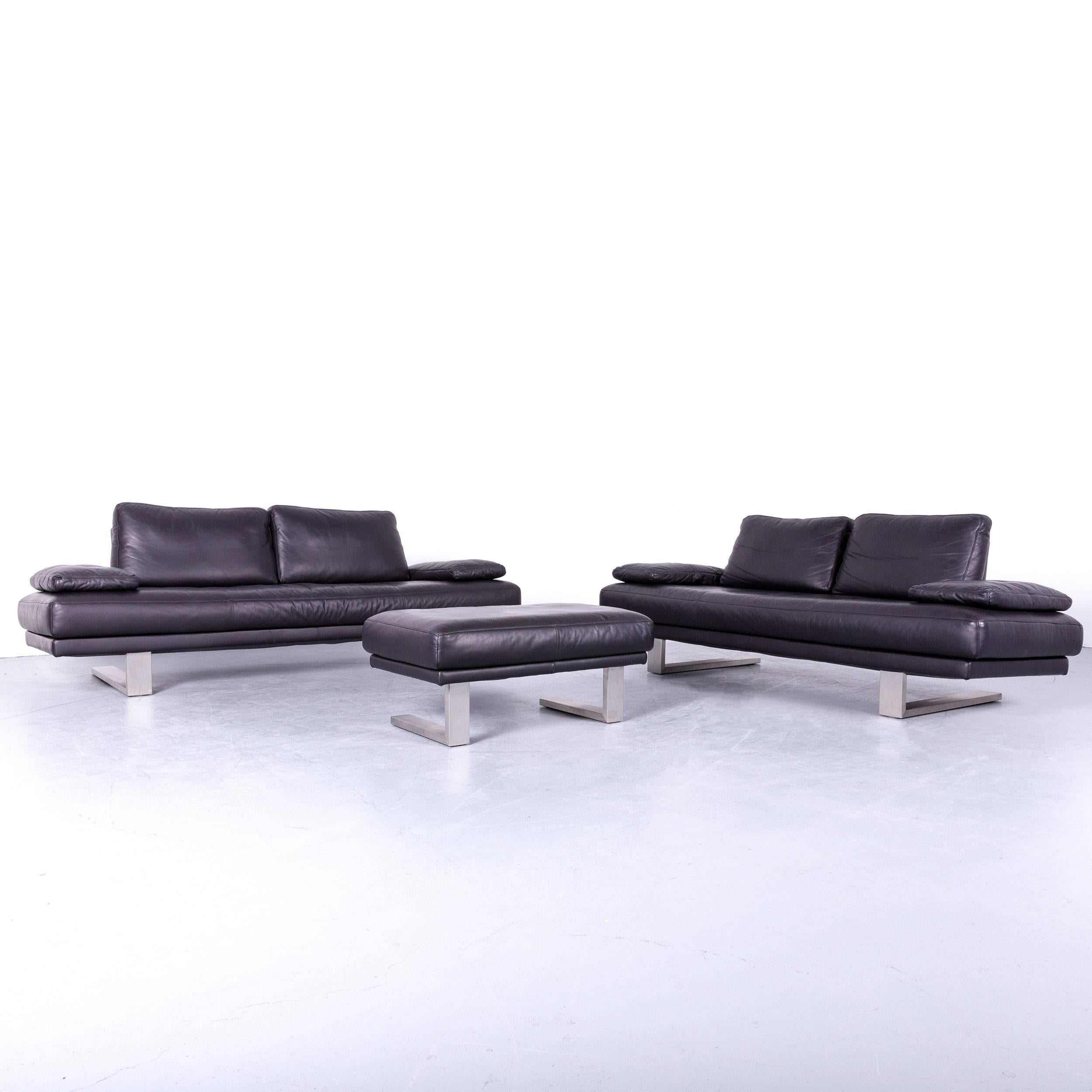 Black colored original Rolf Benz 6600 sofa set, including two sofas and one footstool, in a minimalistic and modern design, made for pure comfort and style.