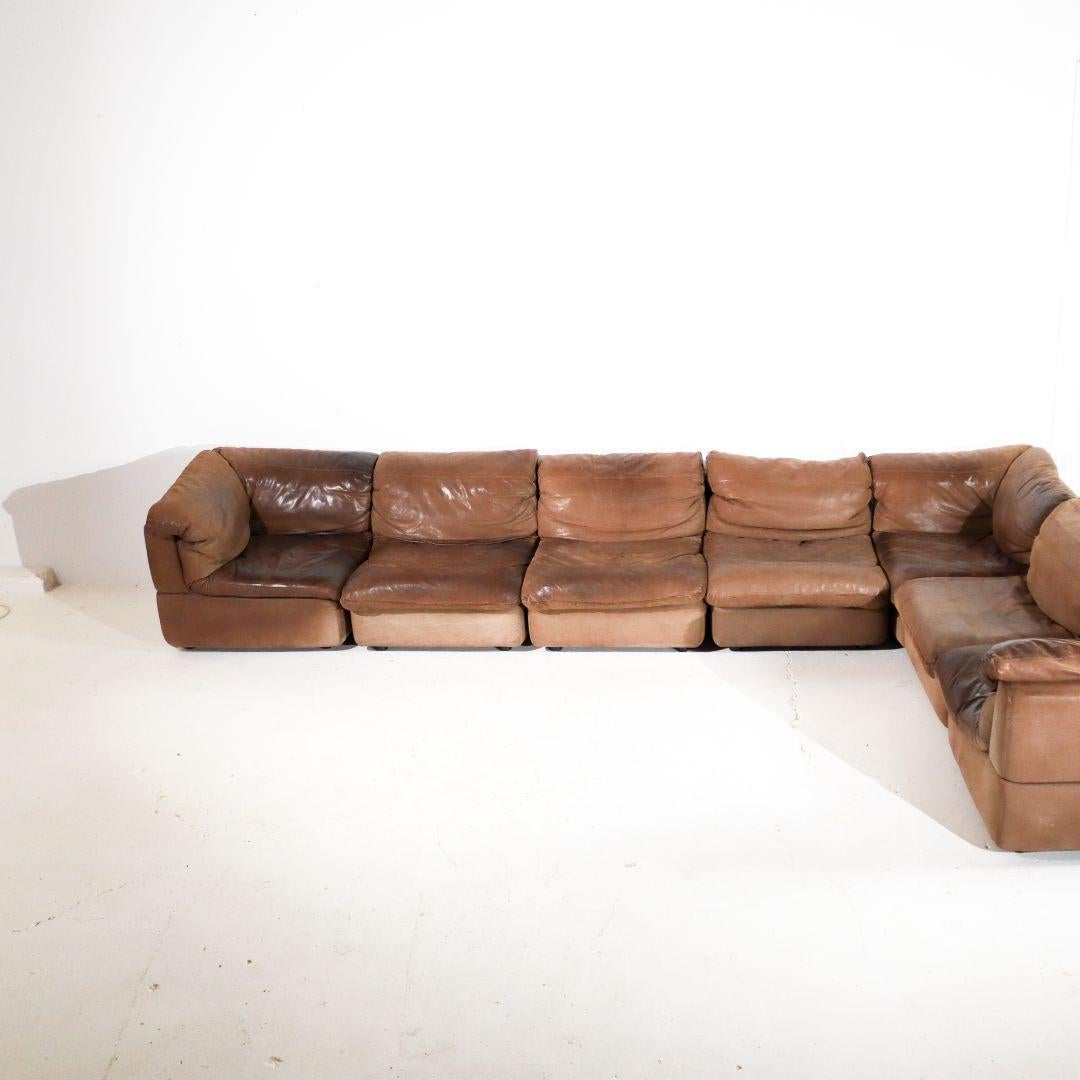 This beautiful 7-piece modular leather sofa was manufactured by Rolf Benz in Germany. It is a pure 70s design with a timeless modern shape. The high-quality aniline leather has a light cognac color and feels soft. The leather has a beautiful patina