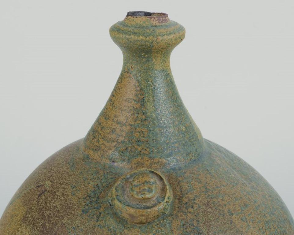 Rolf Fagerberg, (1934-2008). Swedish ceramicist. 
Large round unique ceramic vase.
Glaze in green and sand-colored shades.
Late 20th century.
Signed.
Perfect condition.
Dimensions: Height 25.0 cm. x Diameter 19.0 cm.