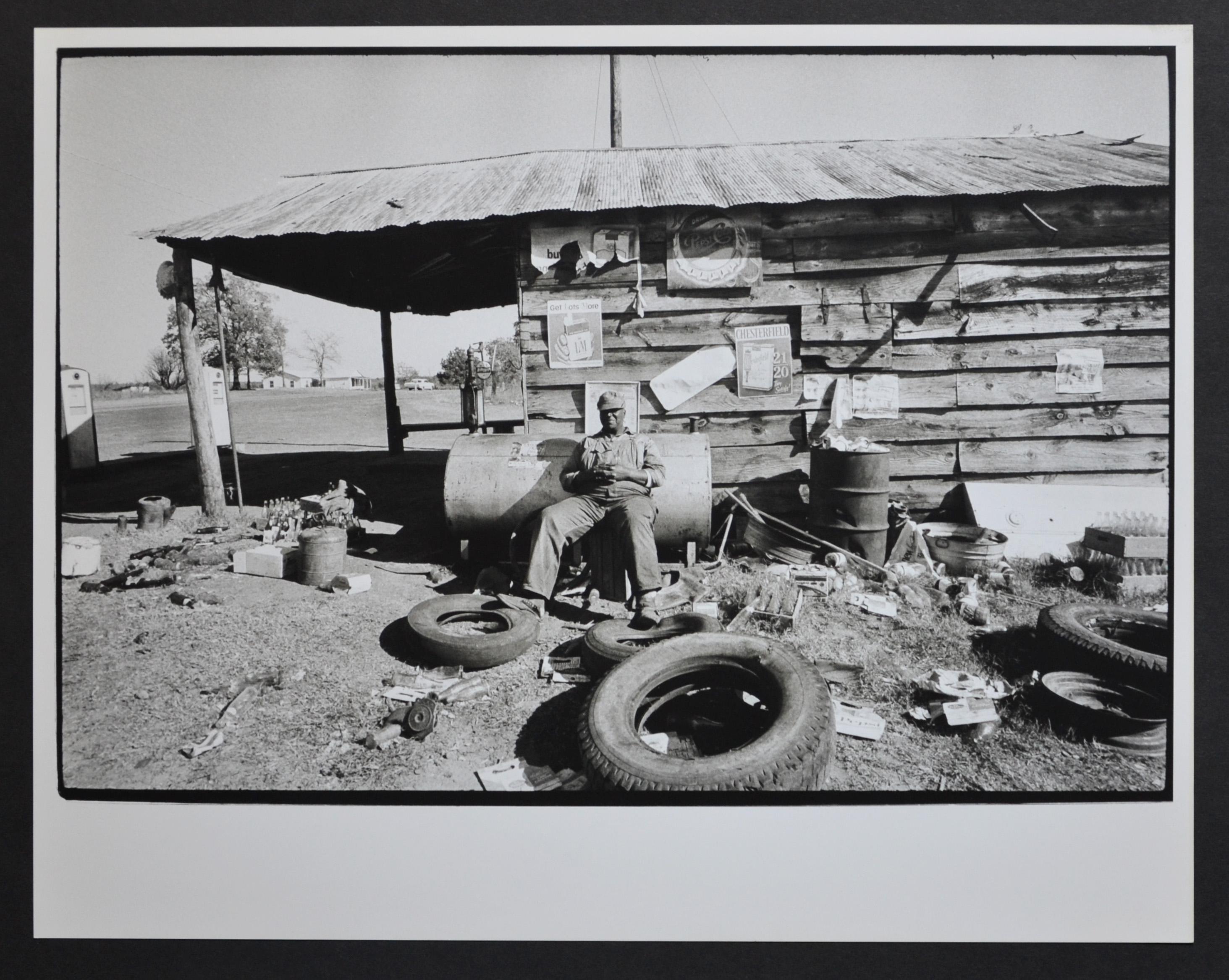 Rolf Gillhausen Black and White Photograph - Mississippi area man sitting in front of his hut, USA early 1960s.