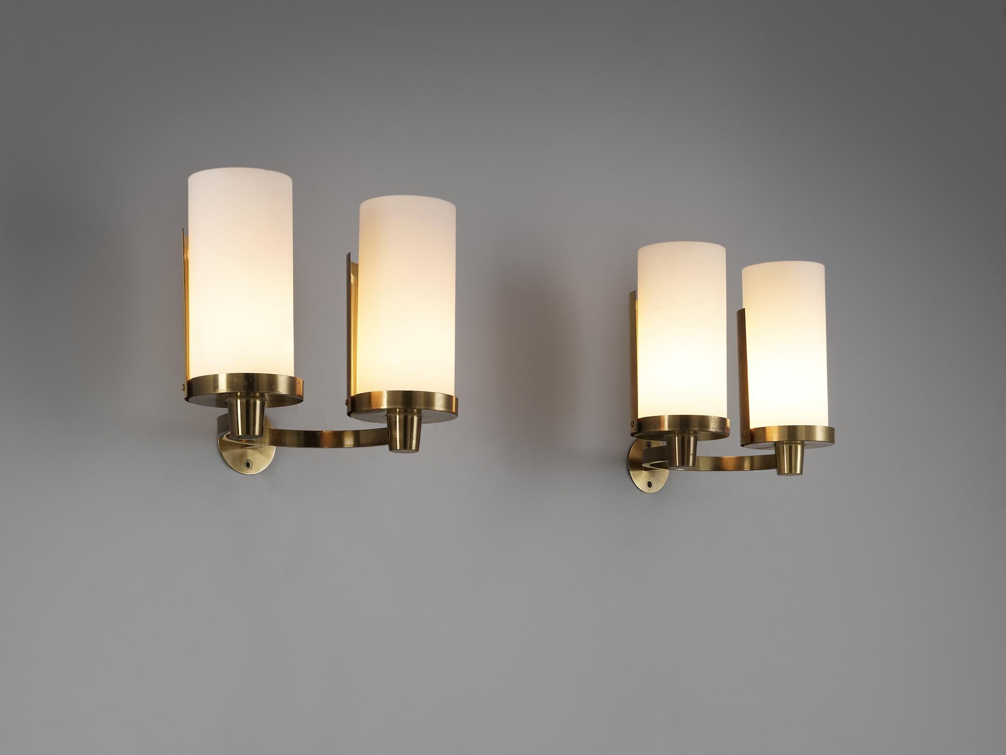 Rolf Saenger Graae, wall lights, brass, glass, Denmark, 1950s. 

Designed by the Danish architect Rolf Saenger Graae (1916-1996) who gained renown for his contributions to ecclesiastical architecture, which primarily involved the creation and
