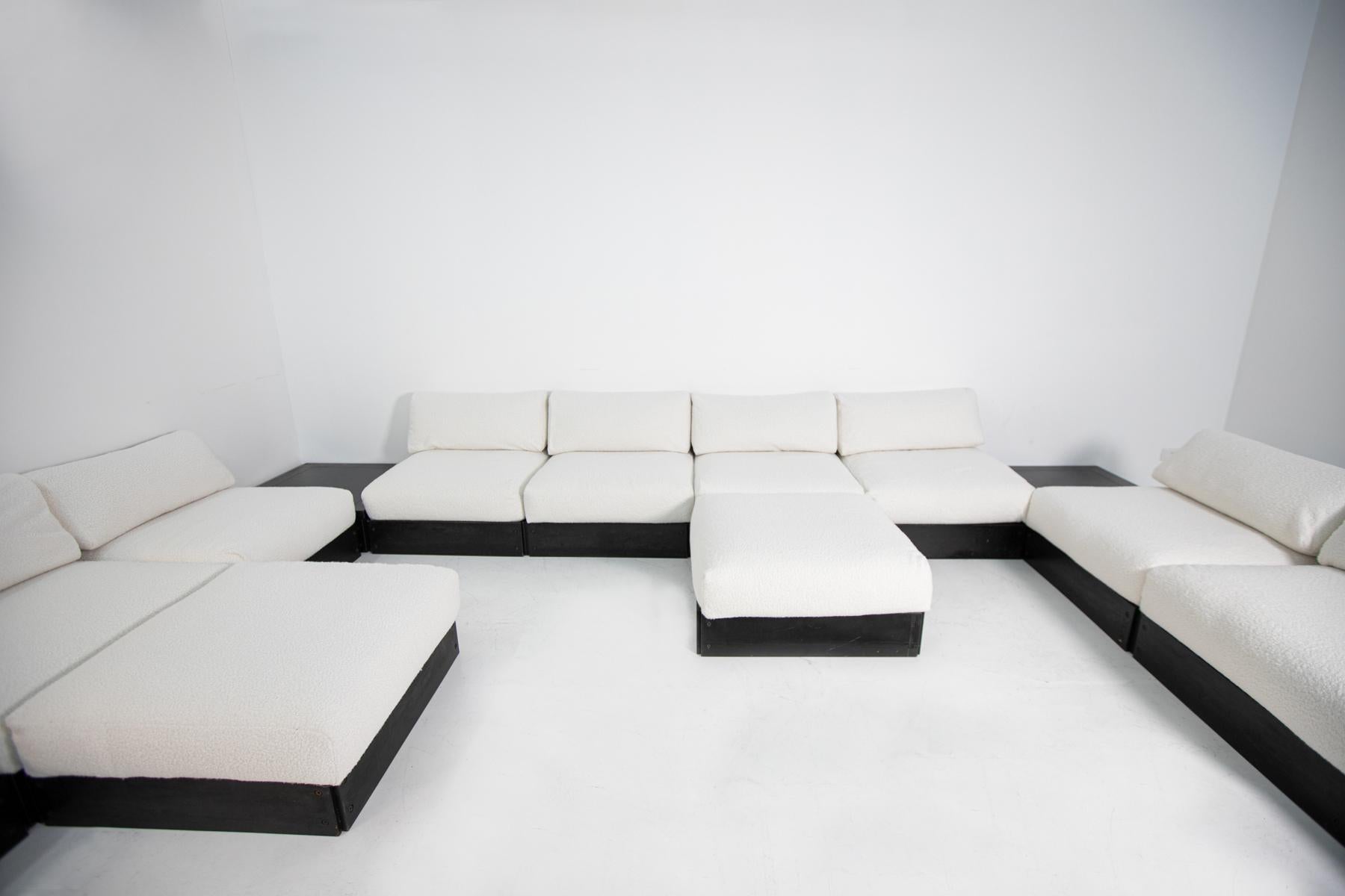 Magnificent and large modular sofa by Heide Rolf. The sofa is called nine-seat sofa, made by ICF, 1970s. The sofa is made of square modules with structure in black stained wood and cushions, both for the seat and the back, in white bouclè fabric.
