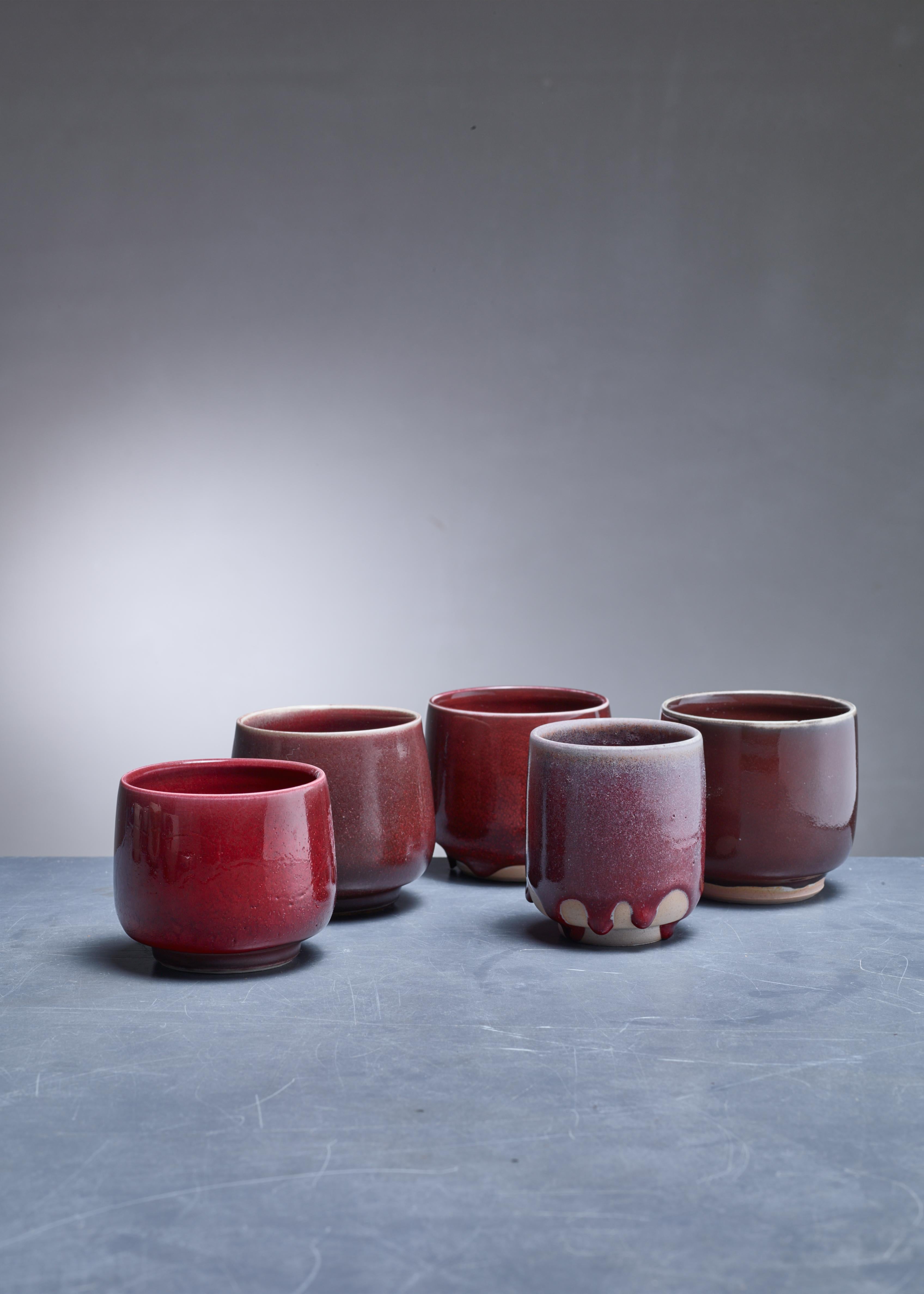 A set of five ceramic vases with a red-brown glaze finish by Rolf Palm.

The pieces are signed by Palm with the year of production (1991 and 1996). Measures: The shortest vase is 8.5 (3.3 inch) high with a 10 cm (4 inch) diameter. The tallest one