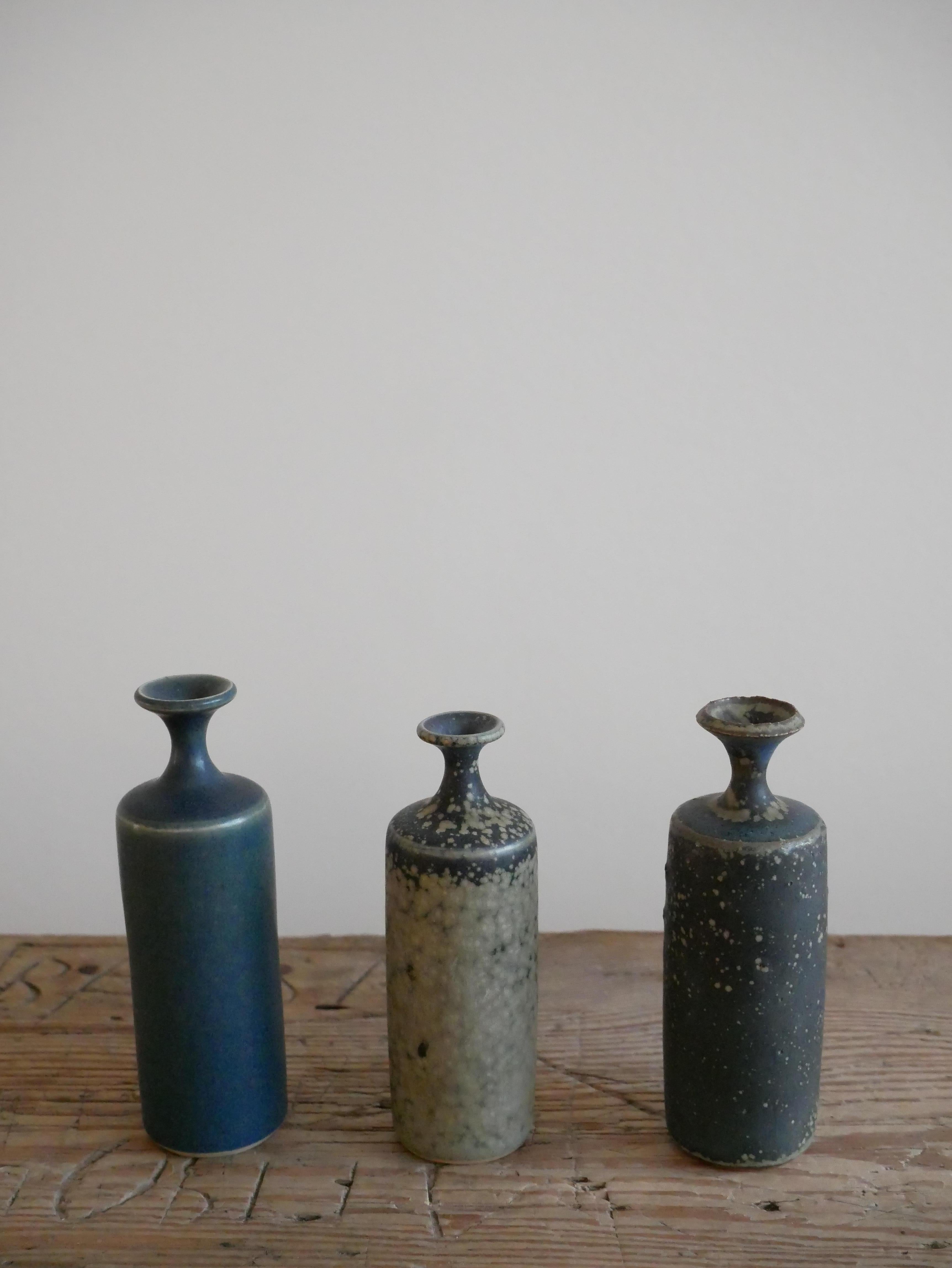A set of three small vases with a lovely multicolored glaze designed by Rolf Palm, made at his workshop in Mölle outside Höganäs in Sweden. 
Rolf Palm was one of Swedens leading ceramicist artists of the 20th century. 
He was born in Höganäs and