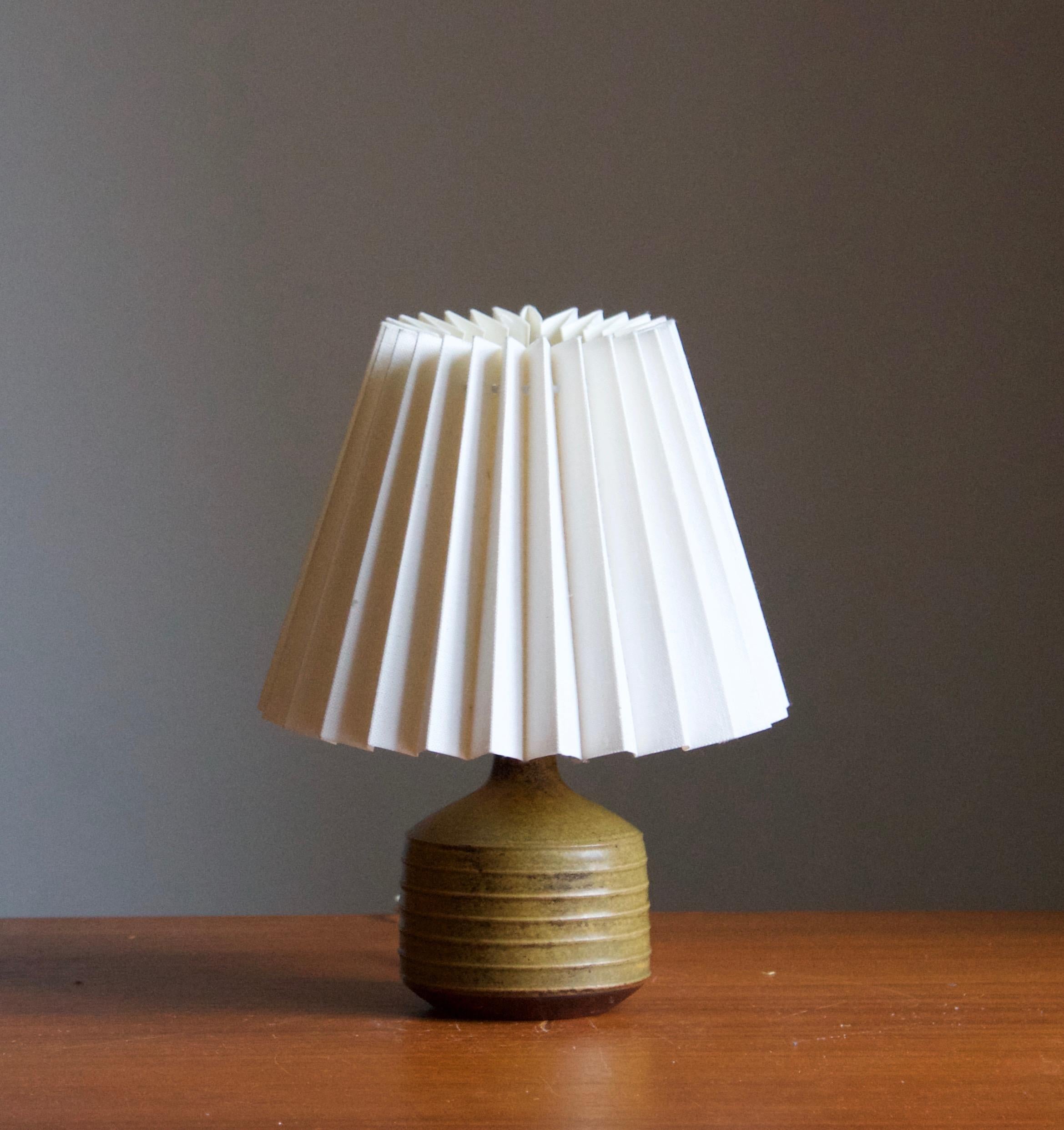 A small table lamp. Produced and designed by Rolf Palm, Sweden.

In glazed stoneware. Stated dimensions exclude lampshade. Height includes socket. Sold without lampshade.