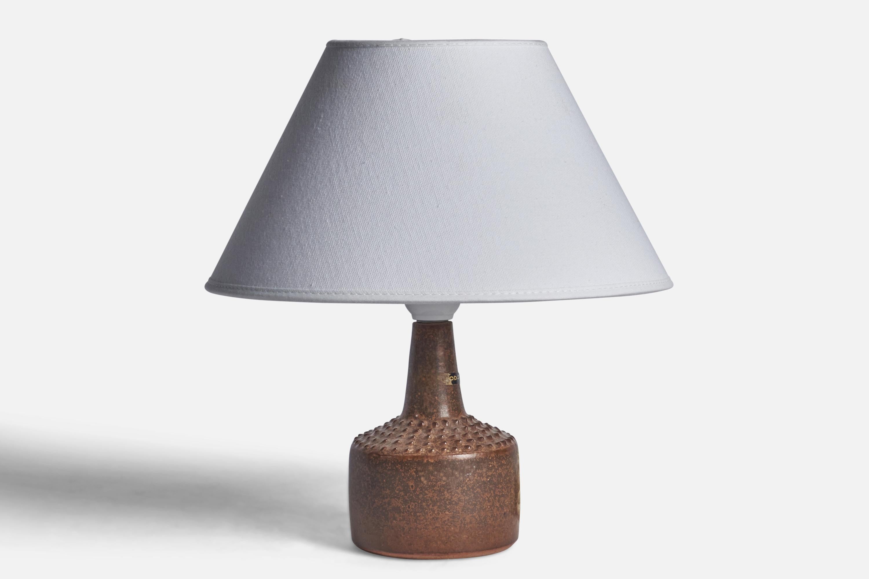A small brown-glazed stoneware table lamp designed and produced by Rolf Palm, Mölle, Sweden, c. 1960s.

Dimensions of Lamp (inches): 8.70” H x 3.75” Diameter
Dimensions of Shade (inches): 7” Top Diameter x 10” Bottom Diameter x 5.5” H 
Dimensions of