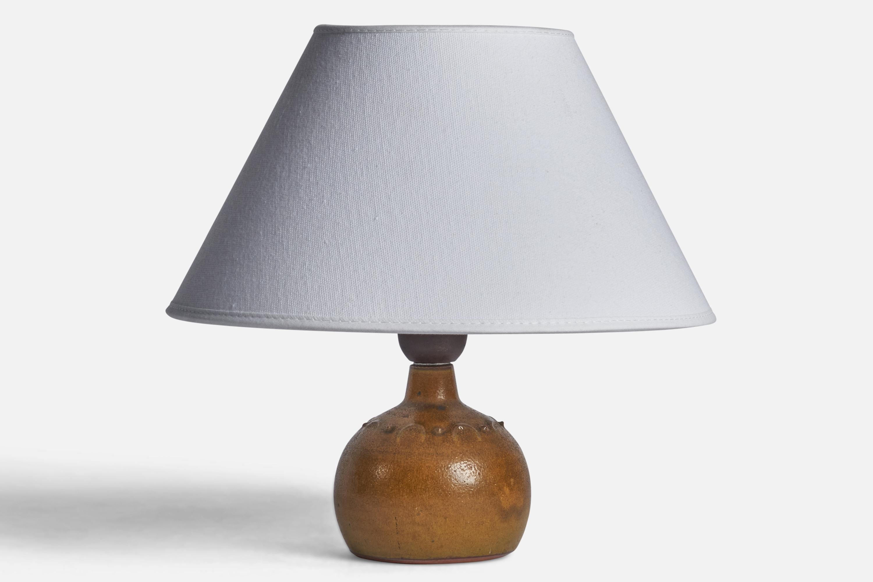 A small brown-glazed stoneware table lamp designed and produced by Rolf Palm, Mölle, Sweden, 1960s.

Dimensions of Lamp (inches): 6.65” H x 3.5” Diameter
Dimensions of Shade (inches): 7” Top Diameter x 10” Bottom Diameter x 5.5” H 
Dimensions of