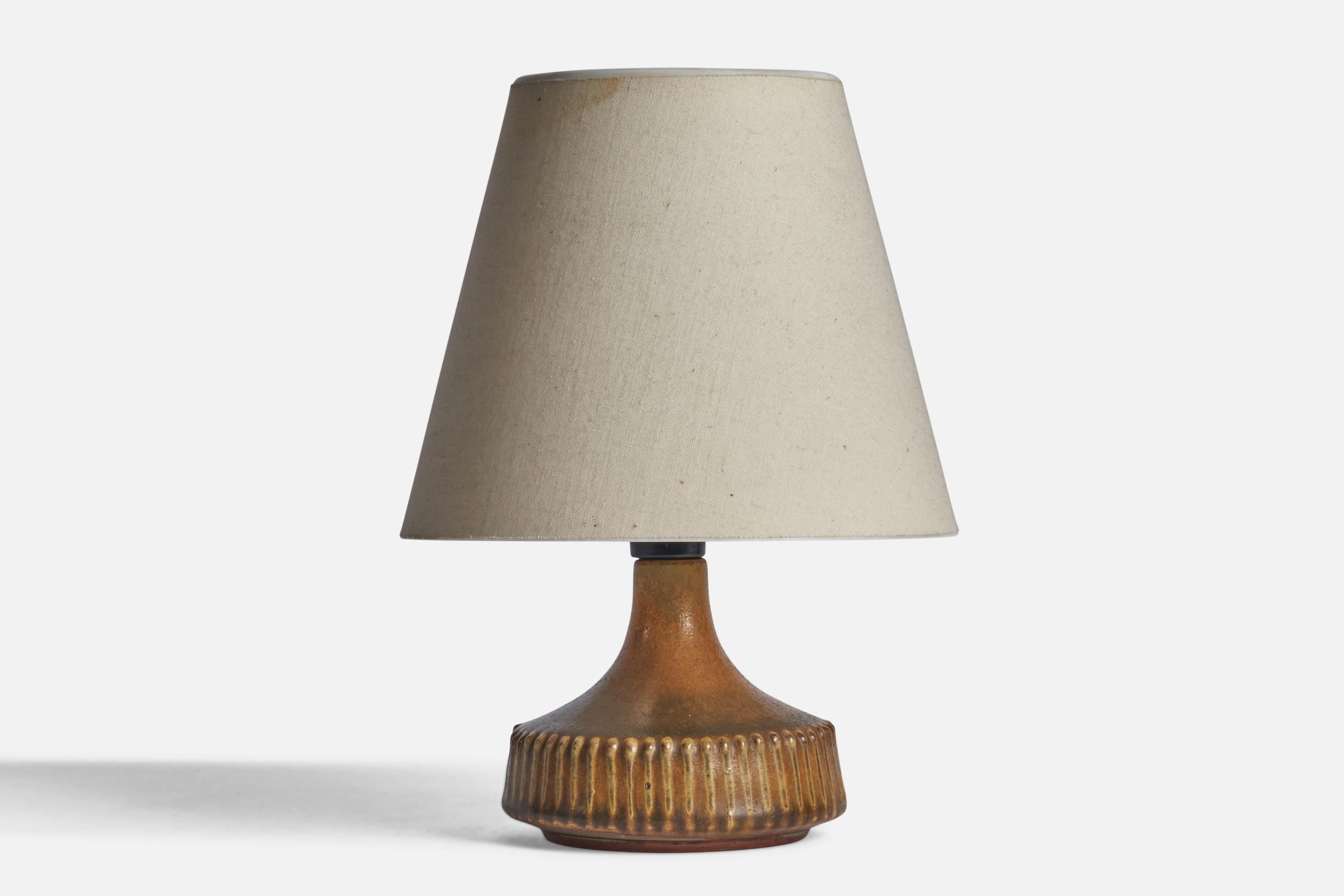 A small brown-glazed stoneware table lamp designed and produced by Rolf Palm, Mölle, Sweden, c. 1960s.

“PALM” stamp on bottom 

Dimensions of Lamp (inches): 5” H x 4” Diameter
Dimensions of Shade (inches): 3.5” Top Diameter x 6.5” Bottom Diameter x