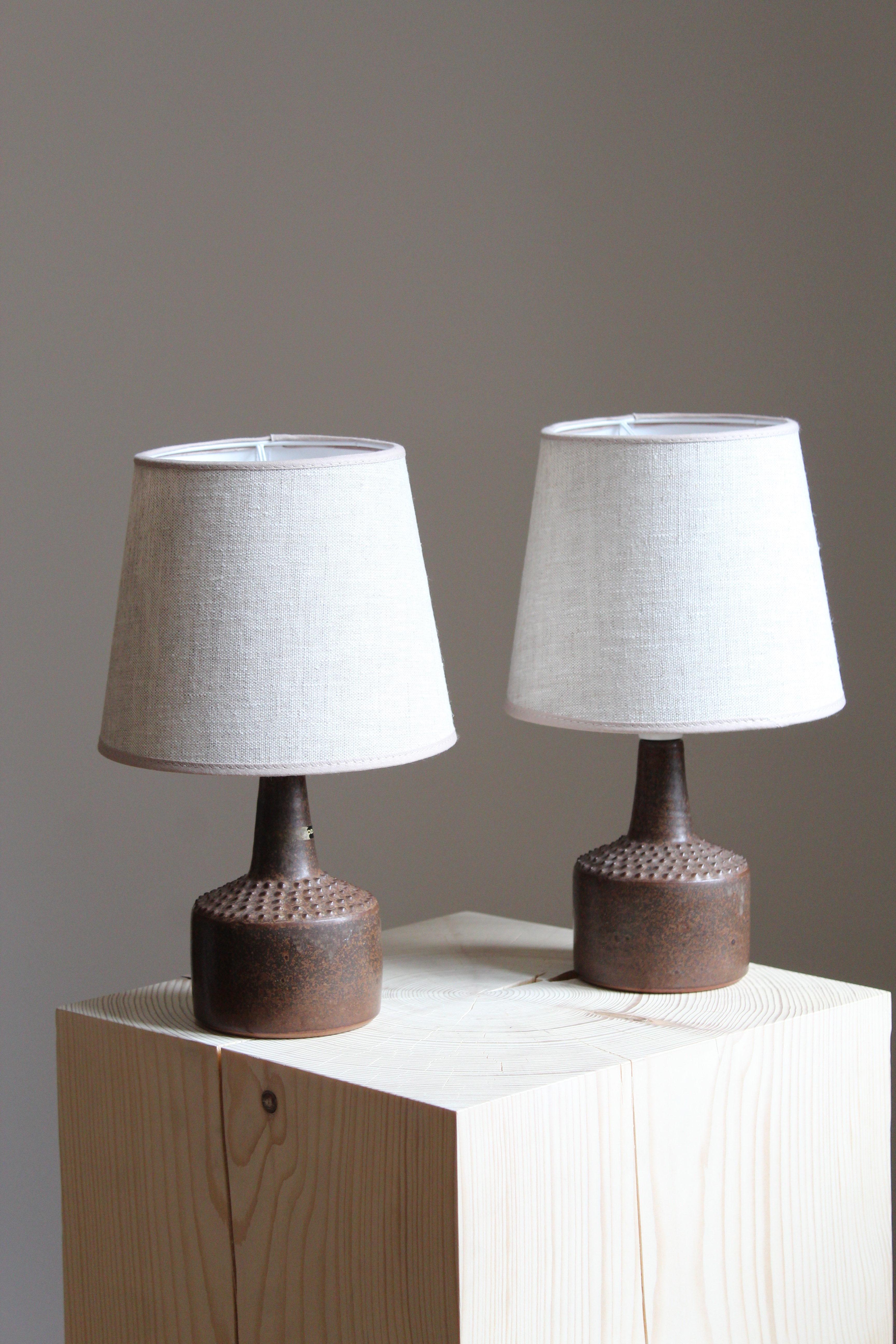 A pair of small table lamps. Produced and designed by Rolf Palm, Sweden.

In glazed stoneware. Lampshades not included.  Dimensions are without shades.

Glaze features brown-black colors.