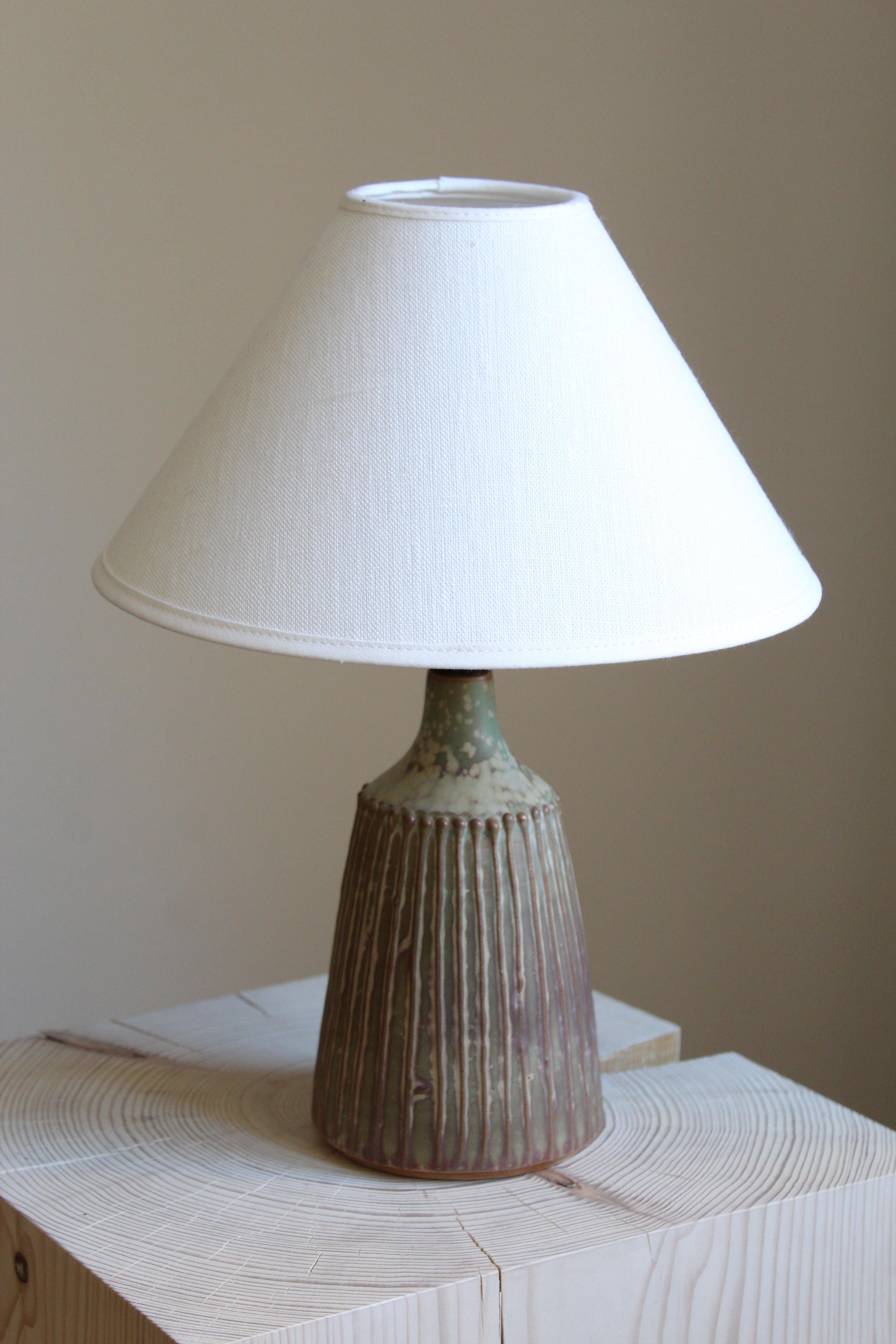 A table lamp. Produced and designed by Rolf Palm, Sweden.

In glazed stoneware. Sold without lampshade. Stated dimensions exclude lampshade.