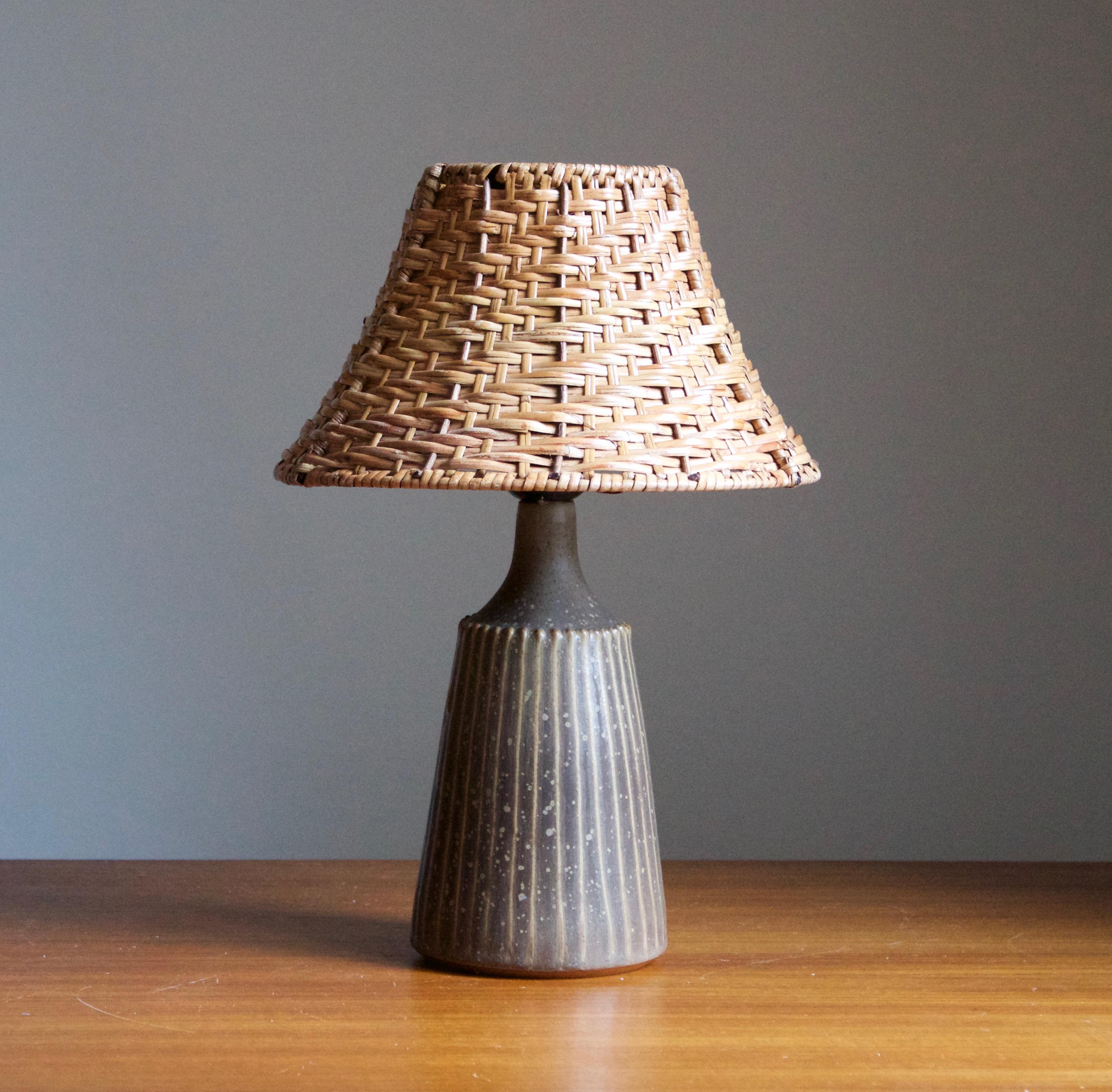 A table lamp. Produced and designed by Rolf Palm, Sweden.

In glazed stoneware. Stated dimensions exclude lampshade. Height includes socket. Illustrated model vintage rattan lampshade can be include upon request.

Glaze features a brown color.