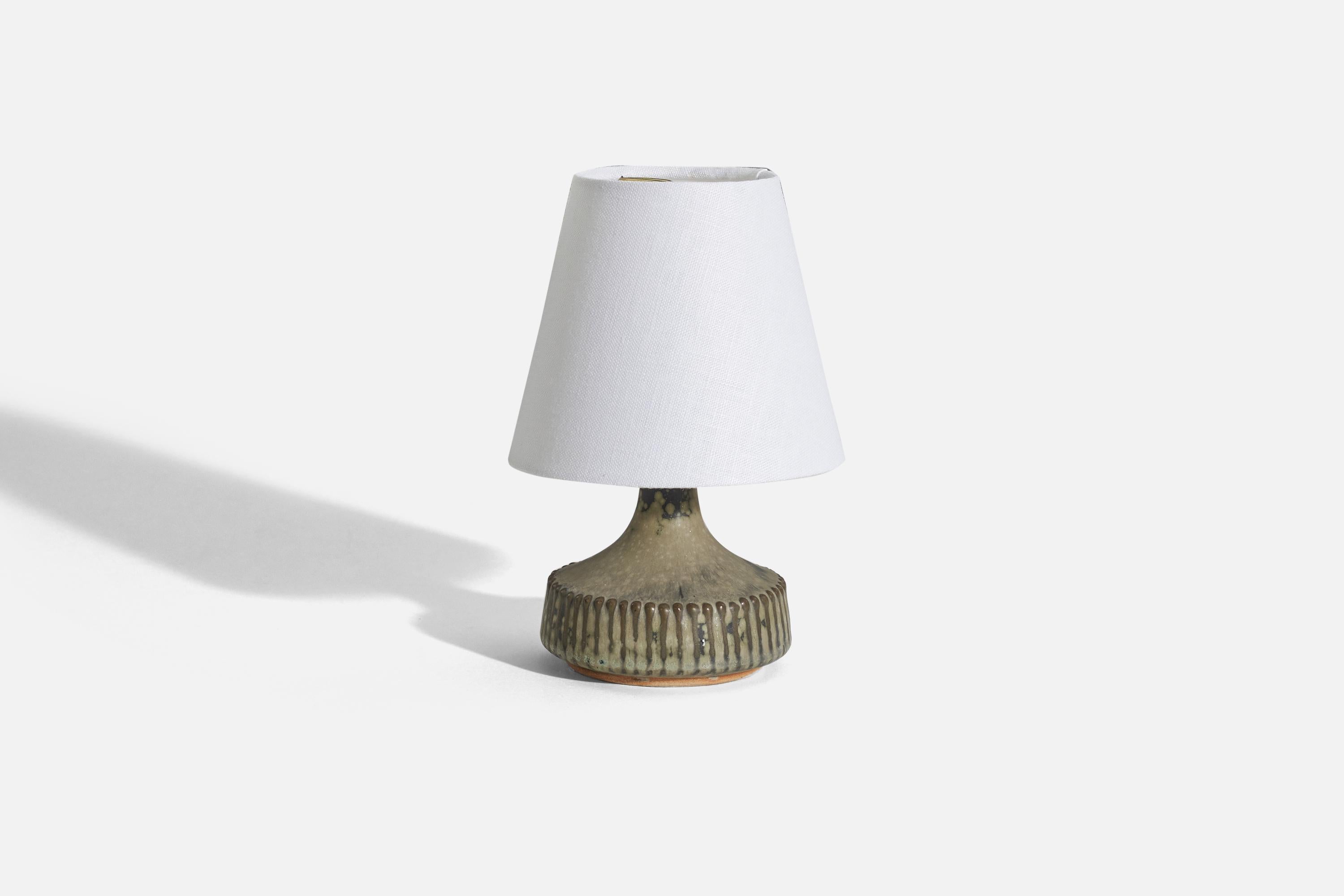 A grey, glazed stoneware table lamp. Produced and designed by Rolf Palm, Sweden, c. 1960s. 

Sold without lampshade. 
Dimensions of Lamp (inches) : 5.125 x 3.75 x 3.75 (H x W x D)
Dimensions of Shade (inches) : 3.125 x 5.125 x 4.4375 (T x B x