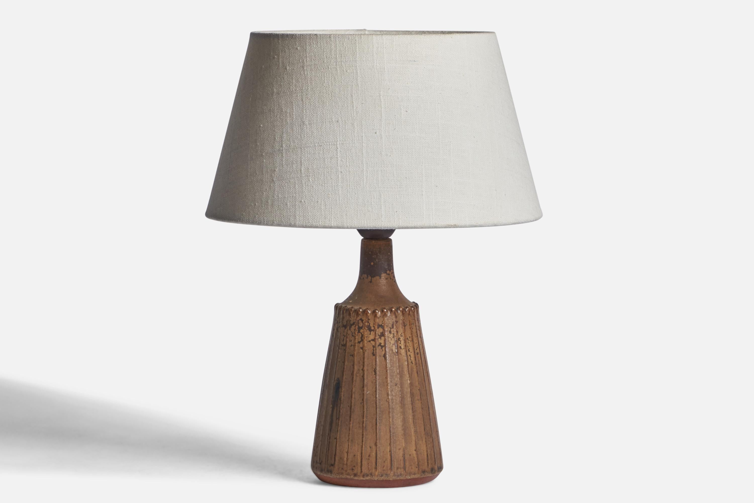 
A brown-glazed stoneware table lamp designed and produced by Rolf Palm, Mölle, Sweden, 1960s.
Dimensions of Lamp (inches): 10.35” H x 4” Diameter
Dimensions of Shade (inches): 7” Top Diameter x 10” Bottom Diameter x 5.5” H 
Dimensions of Lamp with