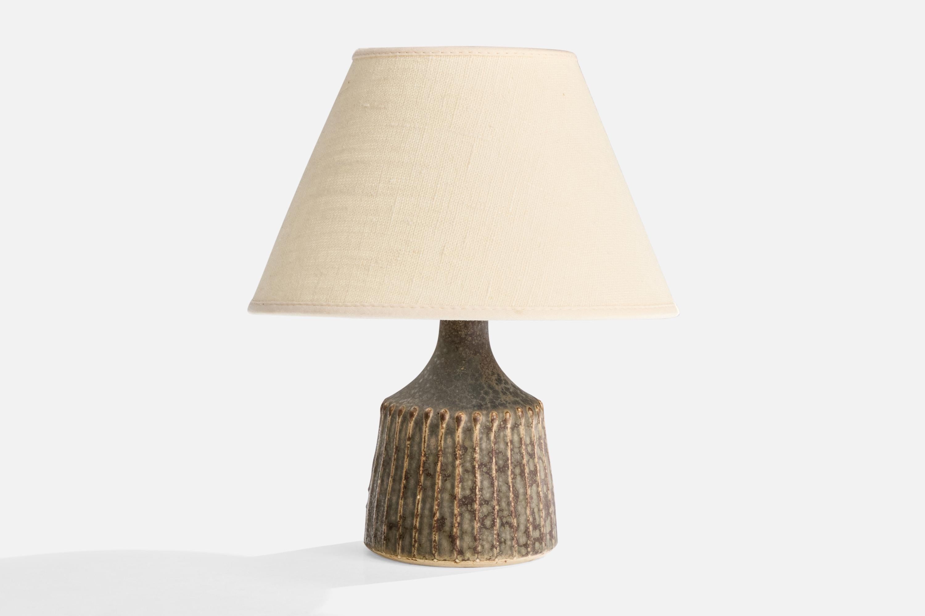 A grey-glazed stoneware table lamp designed and produced by Rolf Palm, Mölle, Sweden, c. 1960s.

Dimensions of Shade (inches): 4” Top Diameter x 8” Bottom Diameter x 5” Height

Dimensions of Lamp with Shade (inches): 9.5”H x 8”Diameter

Overall