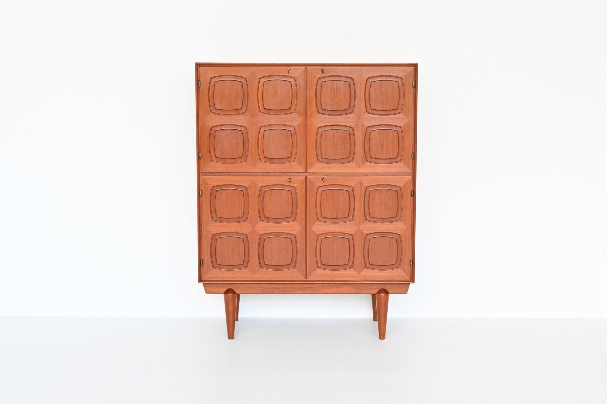 Beautiful and very rare high cabinet designed by Rolf Rastad & Adolf Relling for Gustav Bahus, Norway 1960. This high quality Scandinavian cabinet is executed in teak wood supported by a solid frame. It has four massive doors with a very nice