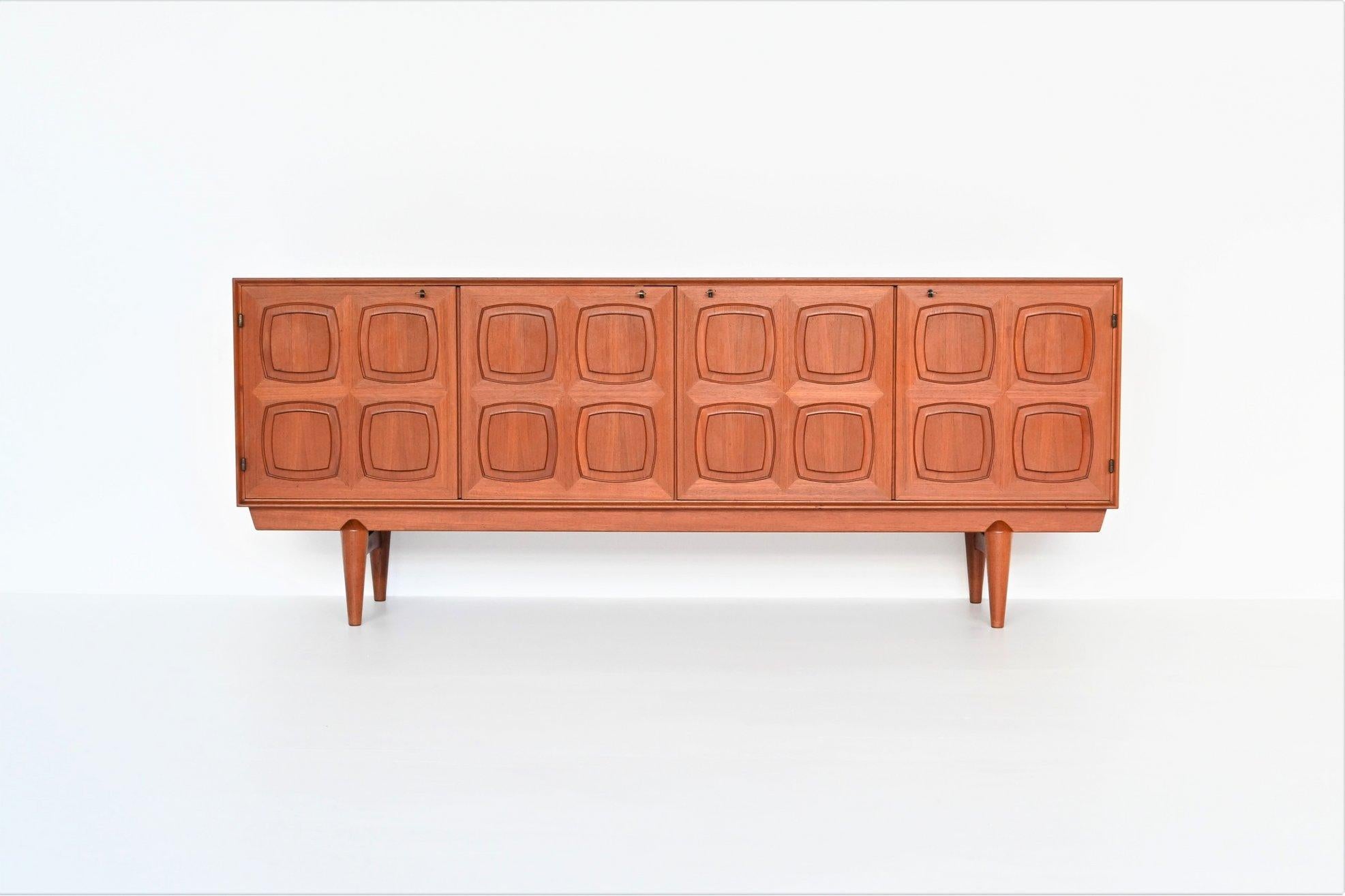 Beautiful and very rare sideboard designed by Rolf Rastad & Adolf Relling for Gustav Bahus, Norway 1960. This high quality Scandinavian cabinet is executed in teak wood supported by a solid frame. It has four massive doors with a very nice graphic