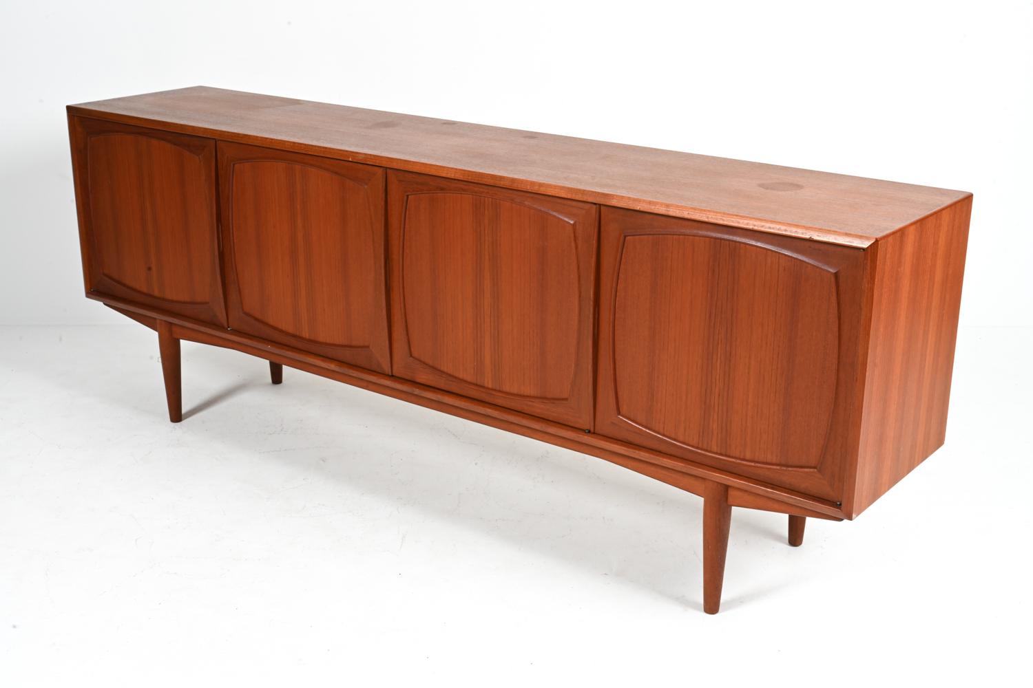 Dive deep into the golden era of Scandinavian design with this breathtaking Teak Mid-Century Sideboard, a harmonious creation by the legendary duo, Rolf Rastad and Adolf Relling. Hailing from the heart of Norway in the 1960s, this piece perfectly