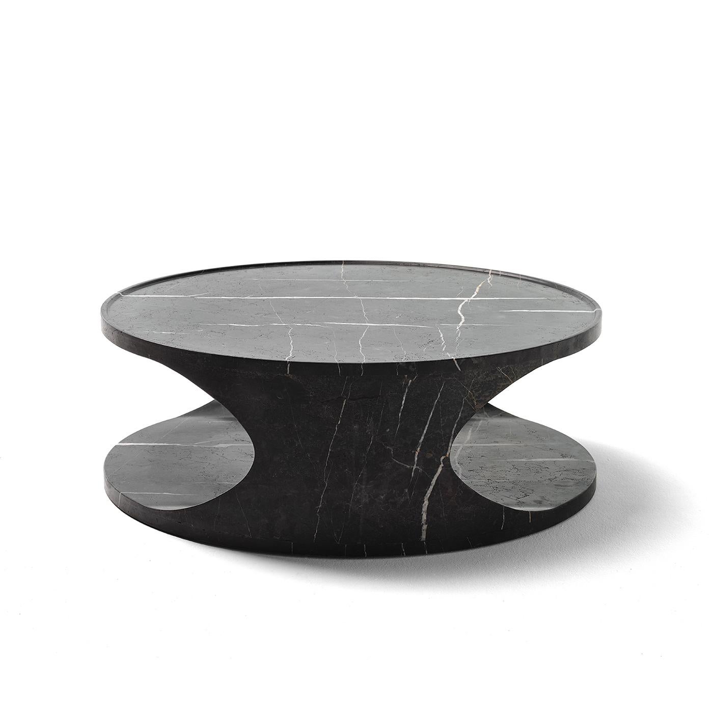 Fashioned of New Saint Laurent Marble, this coffee table is a modern sculpture fit for a minimalist decor. The precious design boasts a fluid silhouette devoid of sharp lines allowing it to blend in a variety of indoor contexts. The internal cavity