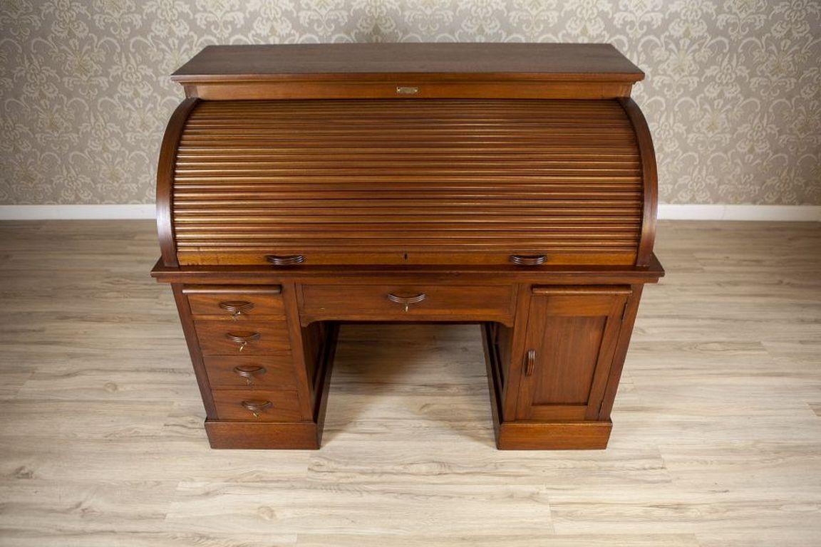 Roll-Top Softwood & Mahogany Veneer Desk Circa 1910

A large roll-top desk from 1910, signed with a plaque in the central part of the add-on unit. In the lower part on the left side, there is a row of drawers, and on the right side, a compartment