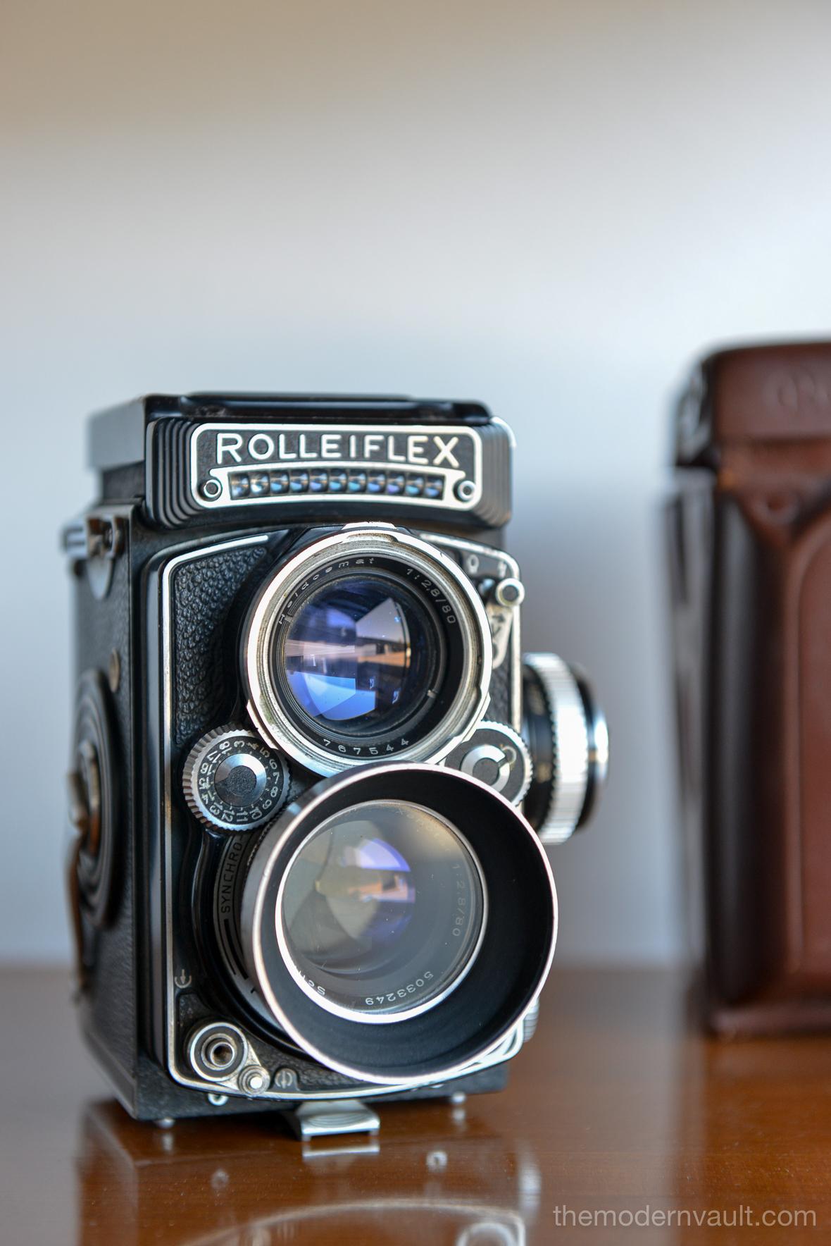 Rolleiflex 2.8E TLR Medium Format Camera with case and accessories, circa 1958. Schneider-Kreuznach Xenotar 2.8 Lens Includes original pistol grip shutter release, Ikophot Light Meter, lens cap, lens hood, original manuals and Rolleigrafie magazine