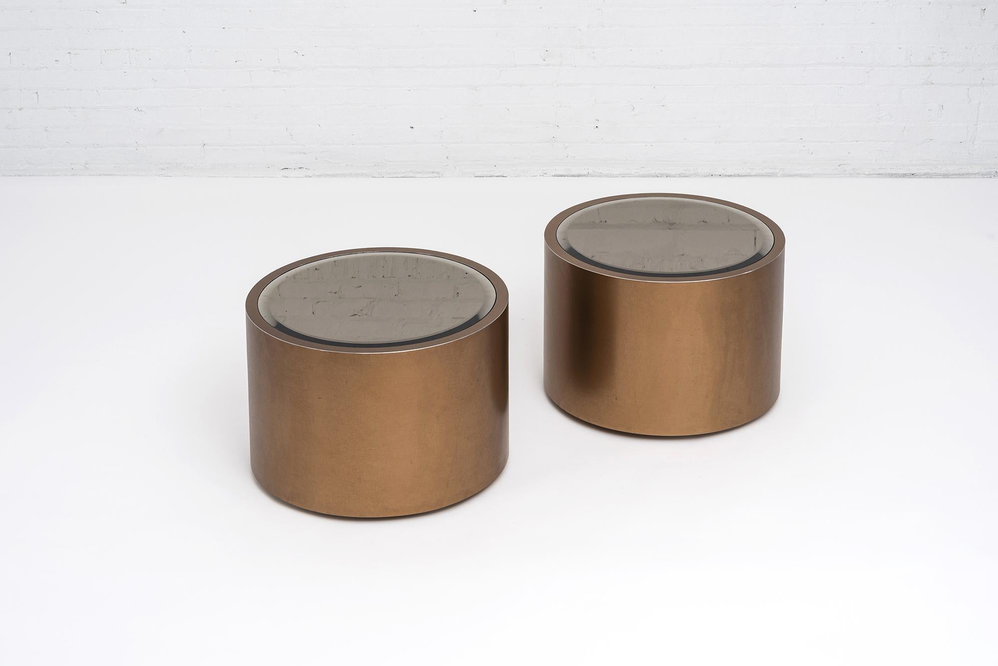 Rolling bronze drum tables with bronze tinted mirror tops, on caster wheels. Steve Chase design circa 1970s.
