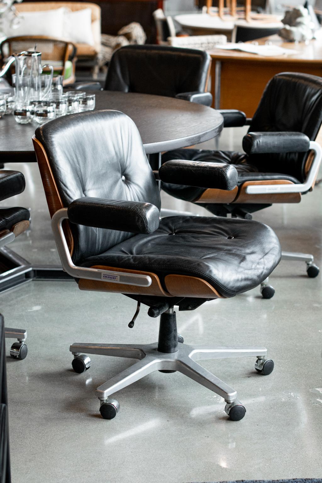 Rolling office/desk armchairs by Martin Stoll for Giroflex, in black leather with wood surrounds. Height adjustable and rocking mechanism, polished cast aluminum base with 5 smooth-running castors. Swivel seats are soft leather and comfortable.
