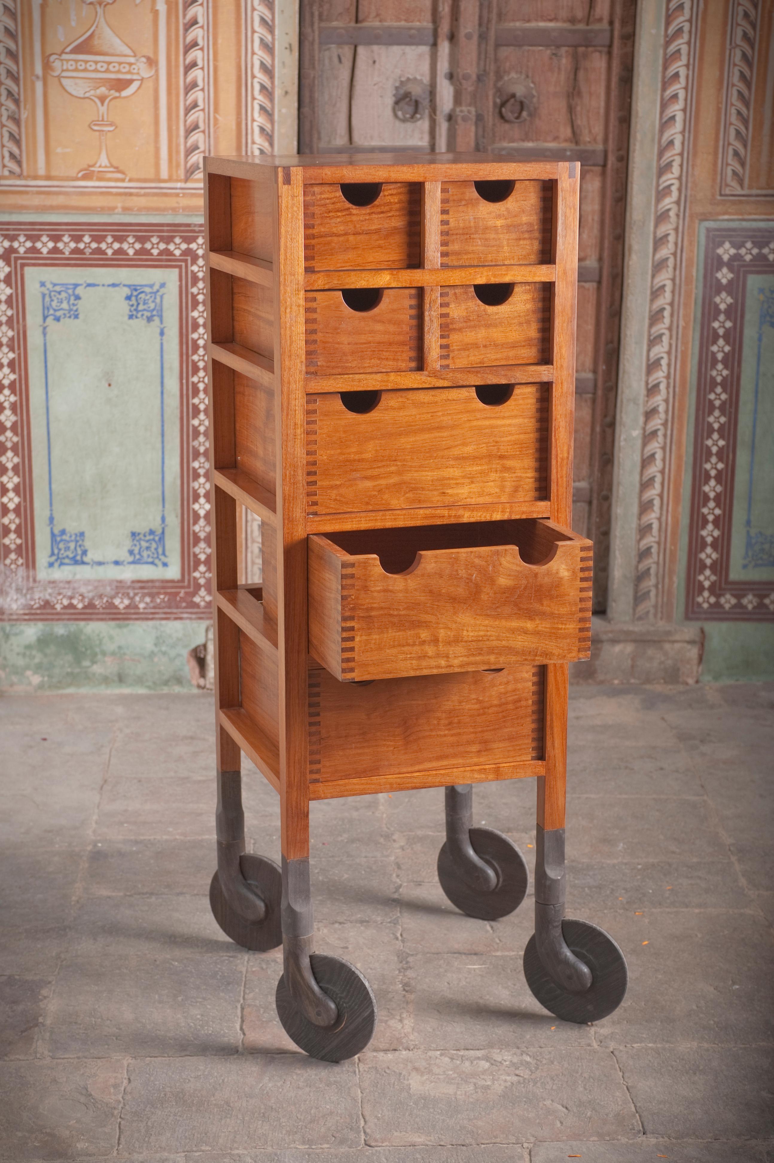 Built entirely of solid wood, the Shaker-influenced Rolling Dresser features open-frame construction and hand-carved, swiveling solid wood casters. No metal fastener is used. Even the axle that the wooden wheels turn on is hardwood. Three full-width
