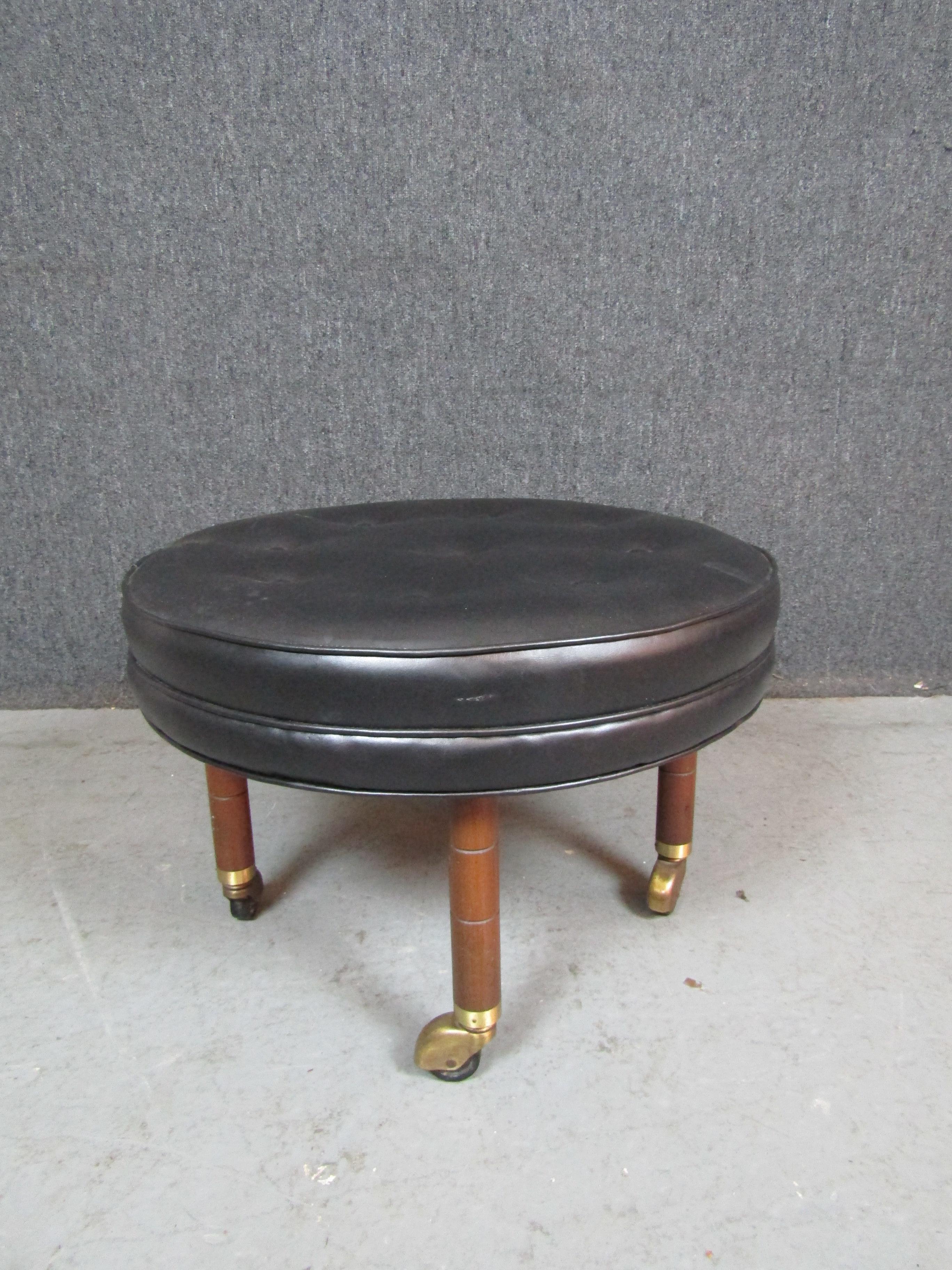 Give your home decor a spin with this charming rolling ottoman from the American craftsmen of Baker Furniture Co. Featuring a wonderful tufted leather cushion and lovely brass casters, this stool is a stunning blend of traditional and modern