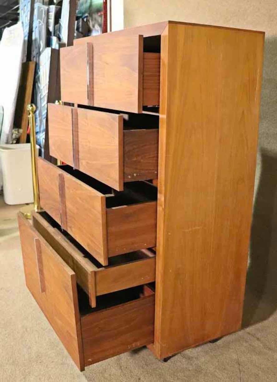 Tall chest of drawers with polished chrome hardware. Five drawers of walnut wood set on rolling casters.
Please confirm location.