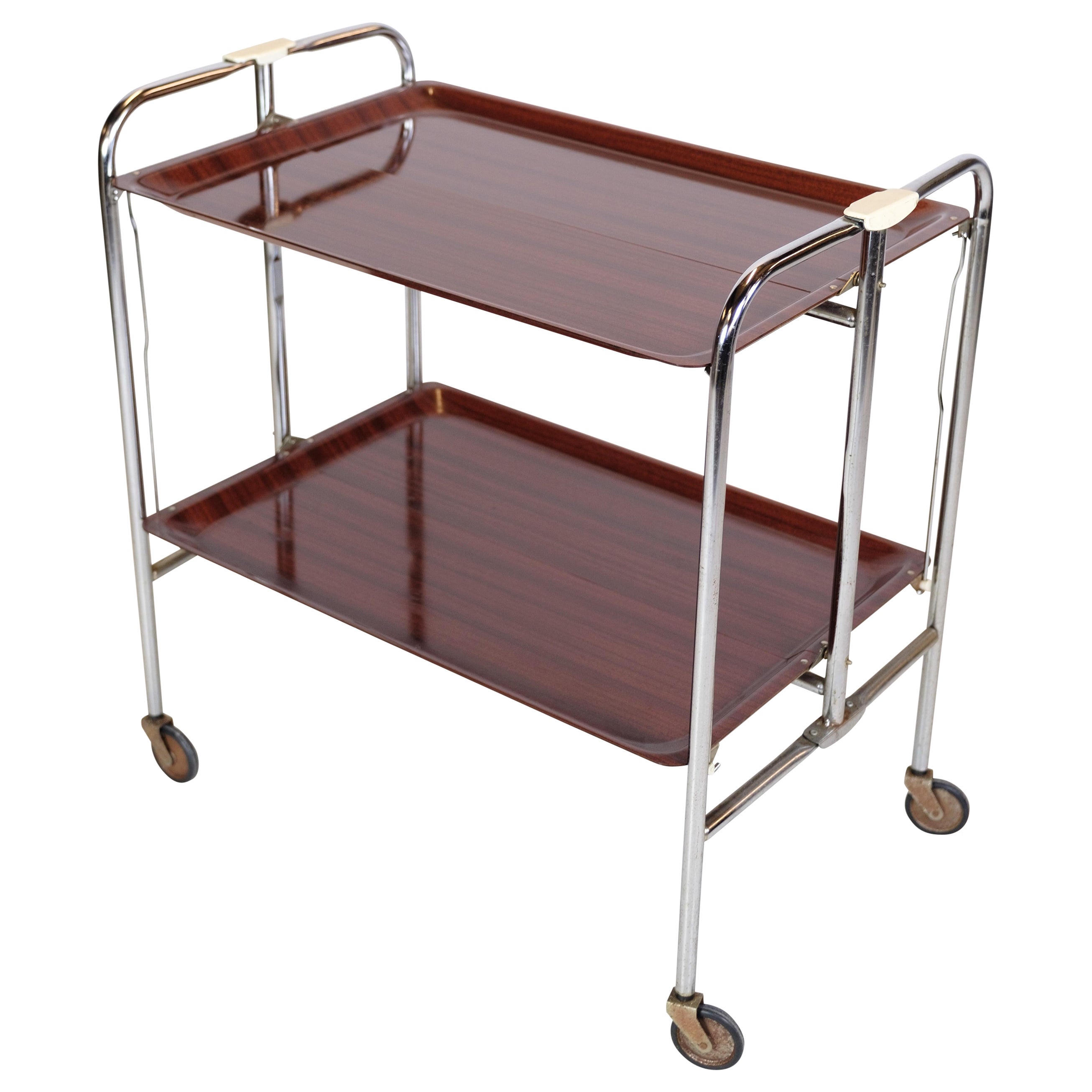 Mesa rodante cromada con superficie de imitación de caoba con ruedas. en venta